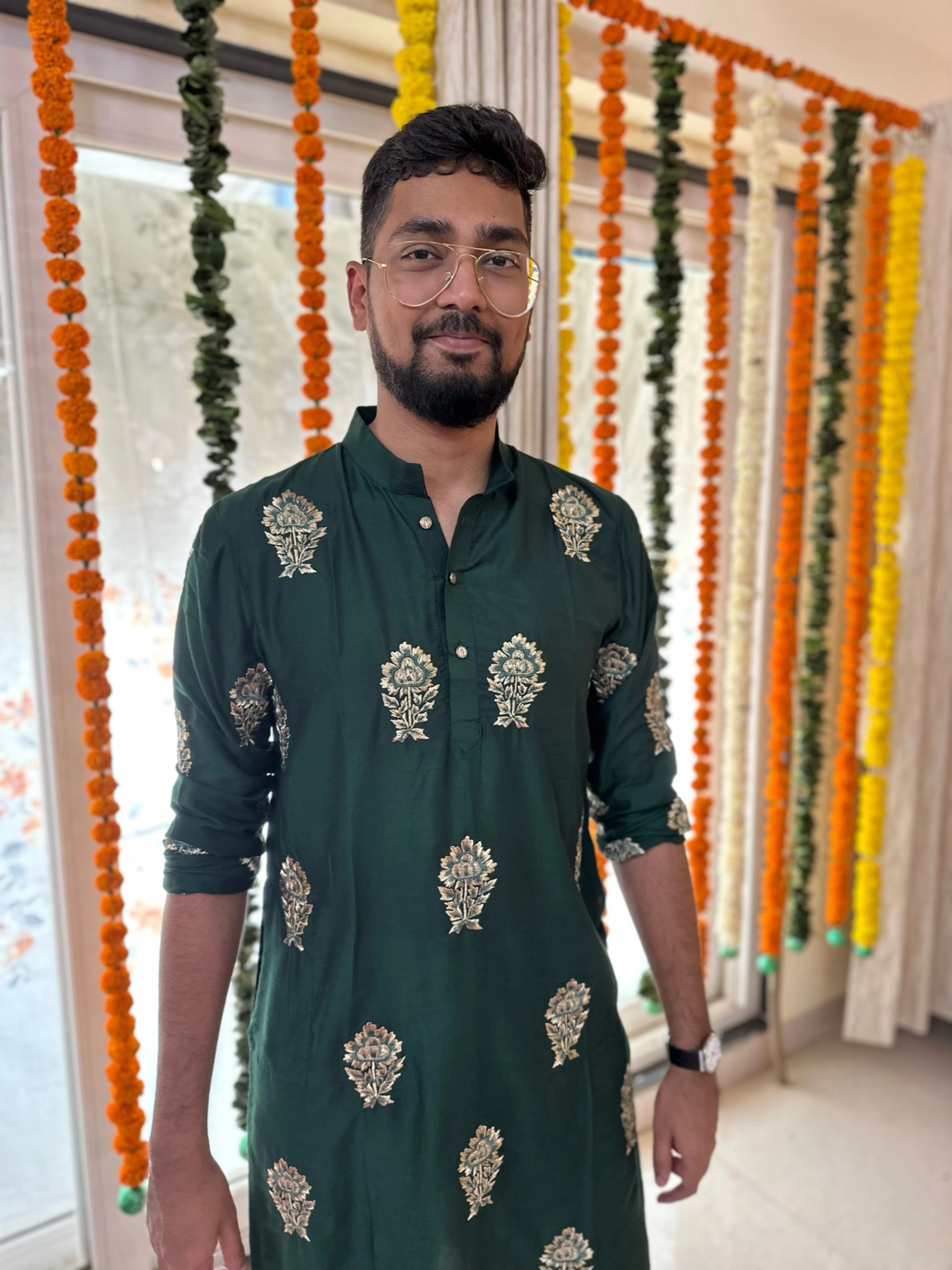 Mahesh from Bangalore posing in a bottle green kurta handcrafted by team Archana Karthick.