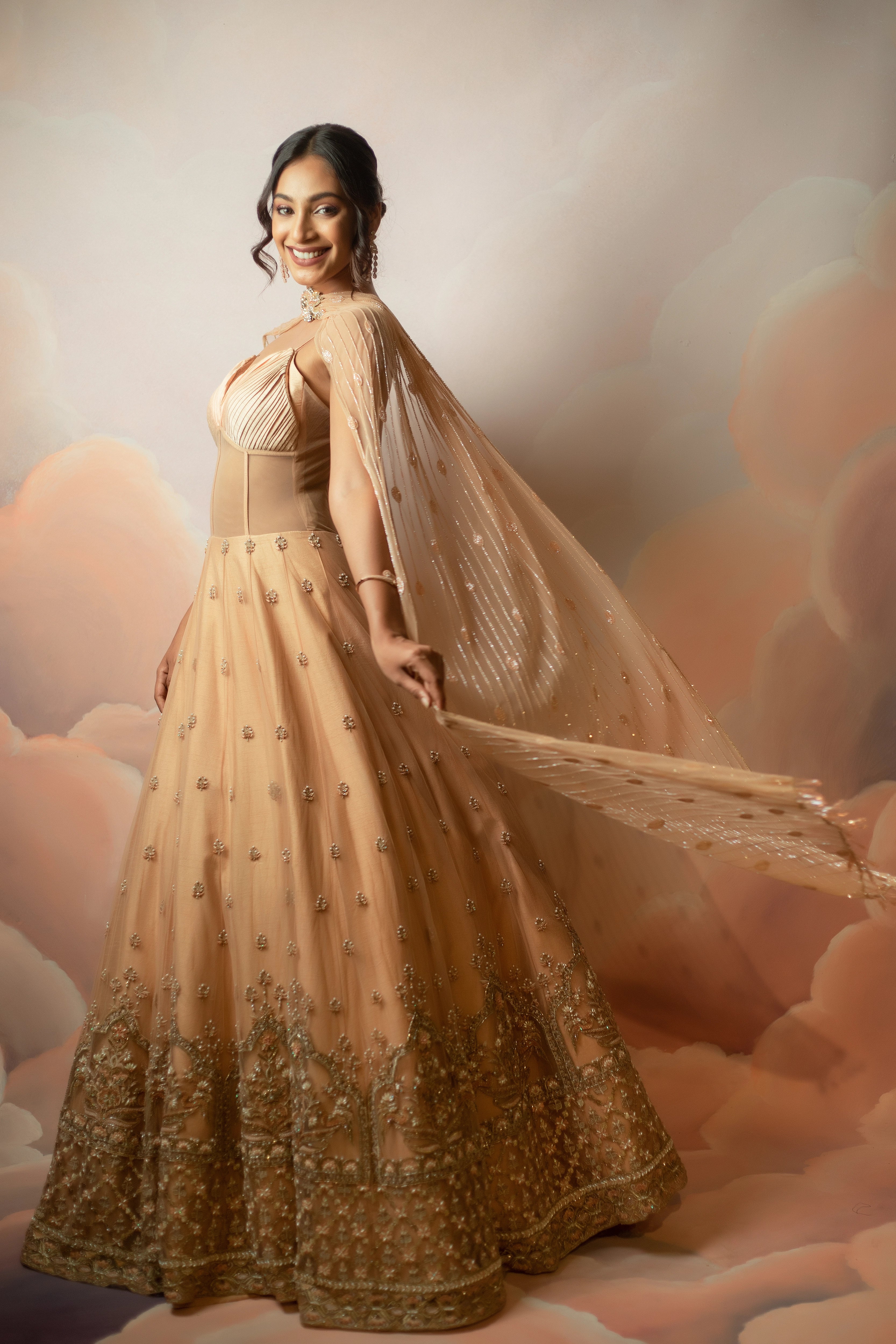 Miss India & Actress Anukreethy Vas in a peach corset gown with draped dupatta, handcrafted with sequin, resham, cutdana, beads and stones by Archana Karthick.