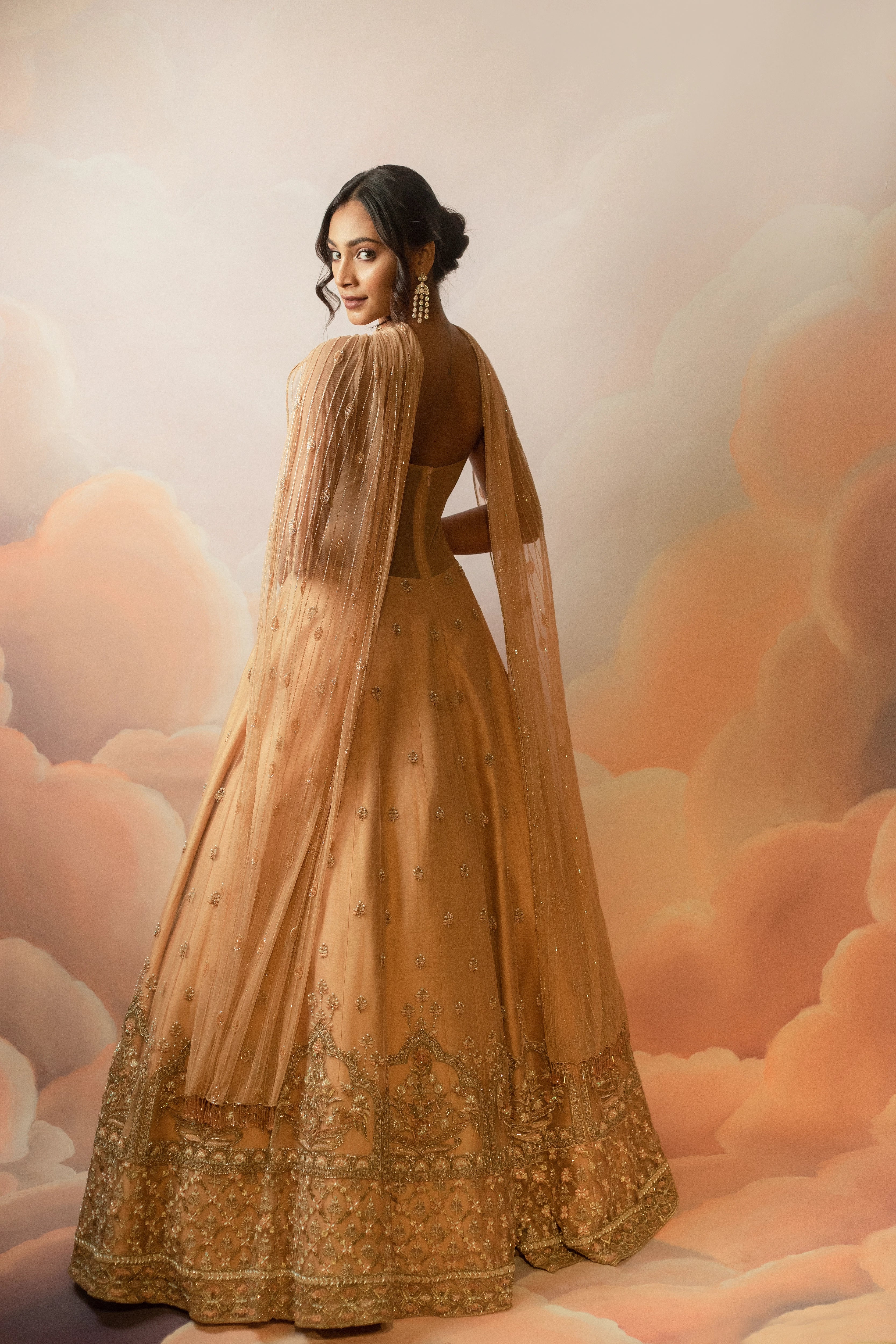 Miss India & Actress Anukreethy Vas showcasing back design in a peach corset gown with draped dupatta, handcrafted with sequin, resham, cutdana, beads and stones by Archana Karthick.