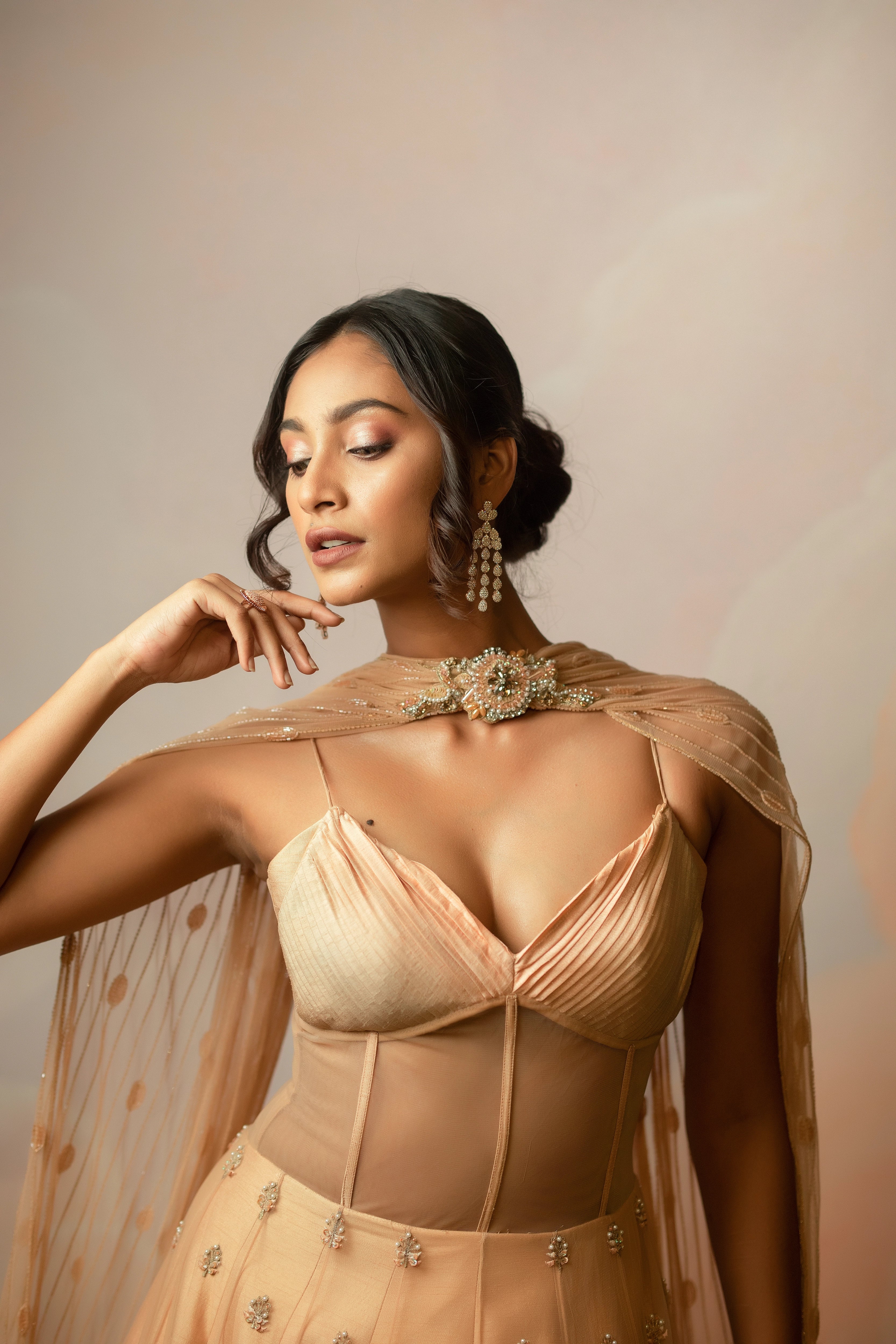 Miss India & Actress Anukreethy Vas showcasing corset in a peach corset gown with draped dupatta, handcrafted with sequin, resham, cutdana, beads and stones by Archana Karthick.