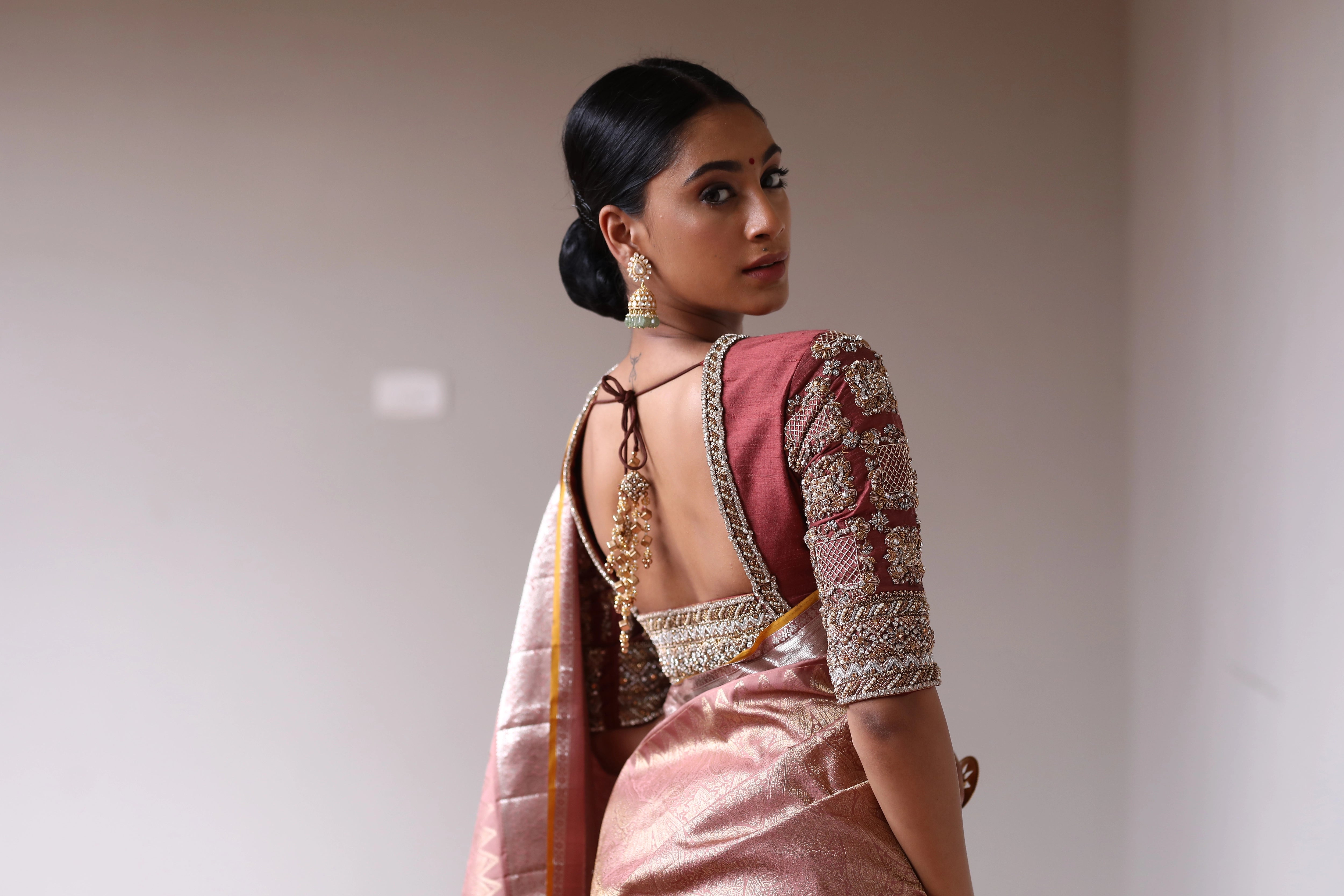Miss India and Actress Anukreethy Vas showcasing back blouse design in a rose gold raw silk blouse, intricately handcrafted with pearls, zardozi, stones and zari by team Archana Karthick.