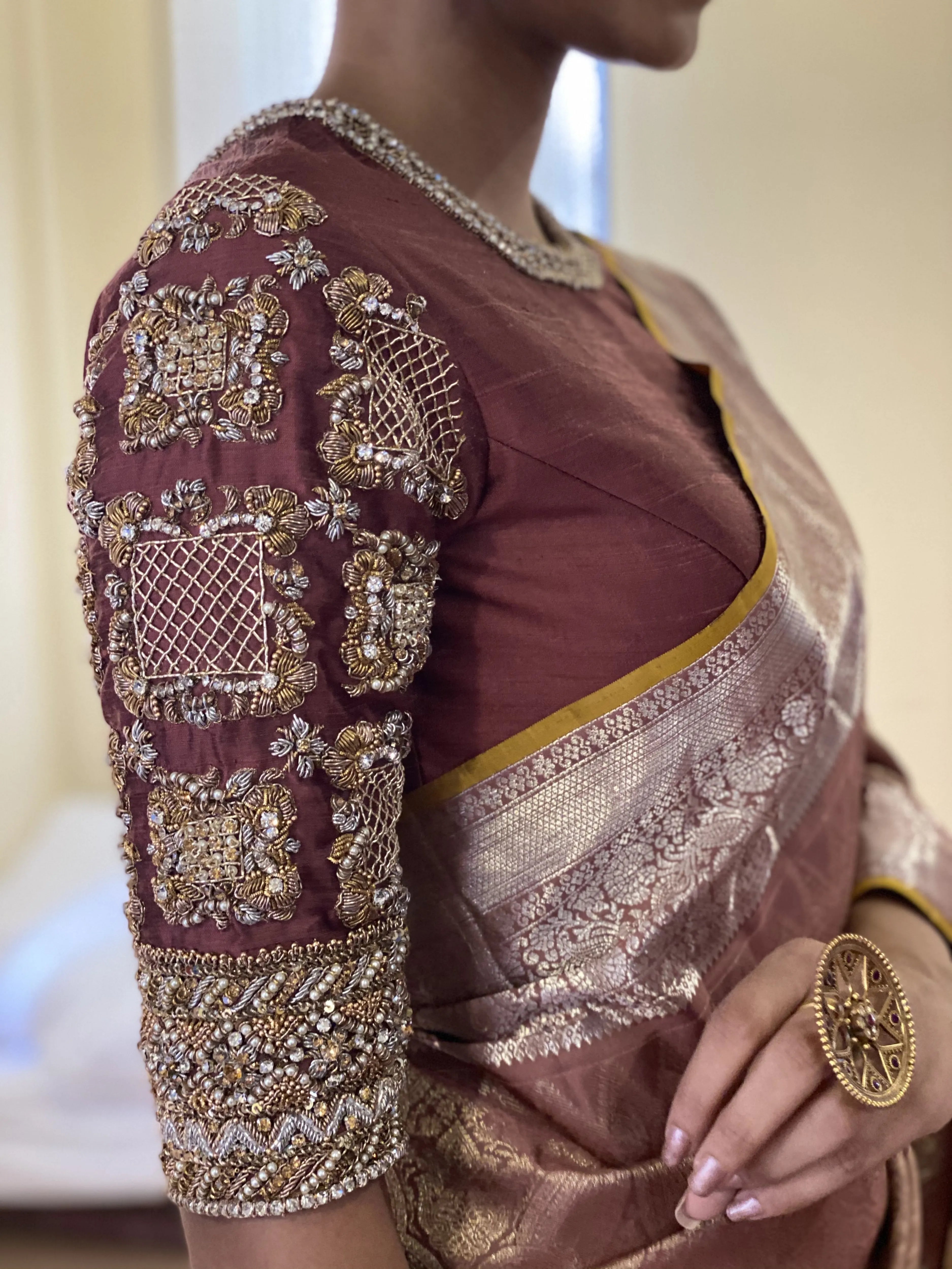 Miss India and Actress Anukreethy Vas showcasing sleeve design in a rose gold raw silk blouse, intricately handcrafted with pearls, zardozi, stones and zari by team Archana Karthick.