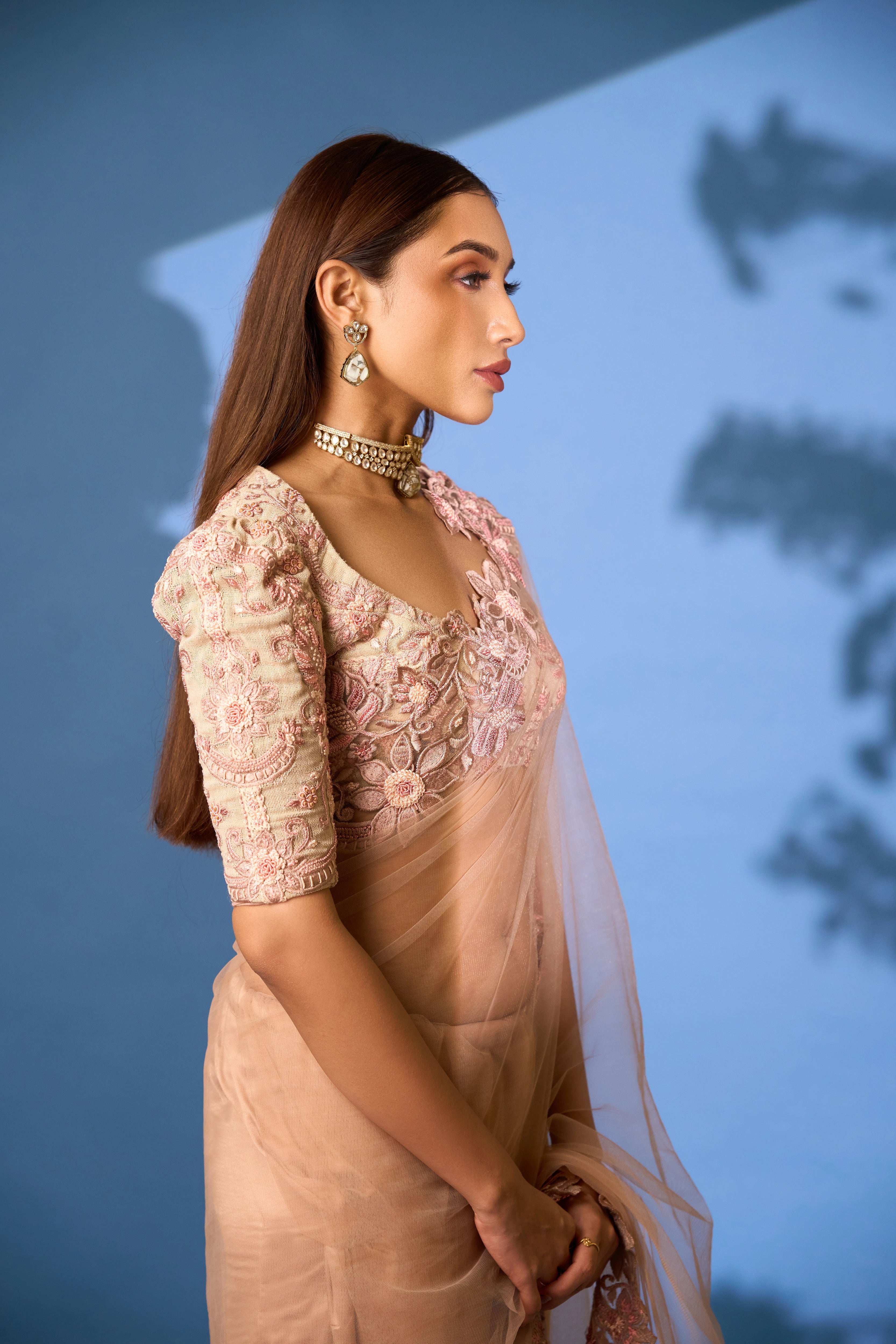 Model Shreya Bhat poses in a net saree & jute blouse in blush pink. Bridal & party look. Blouse sleeve design.