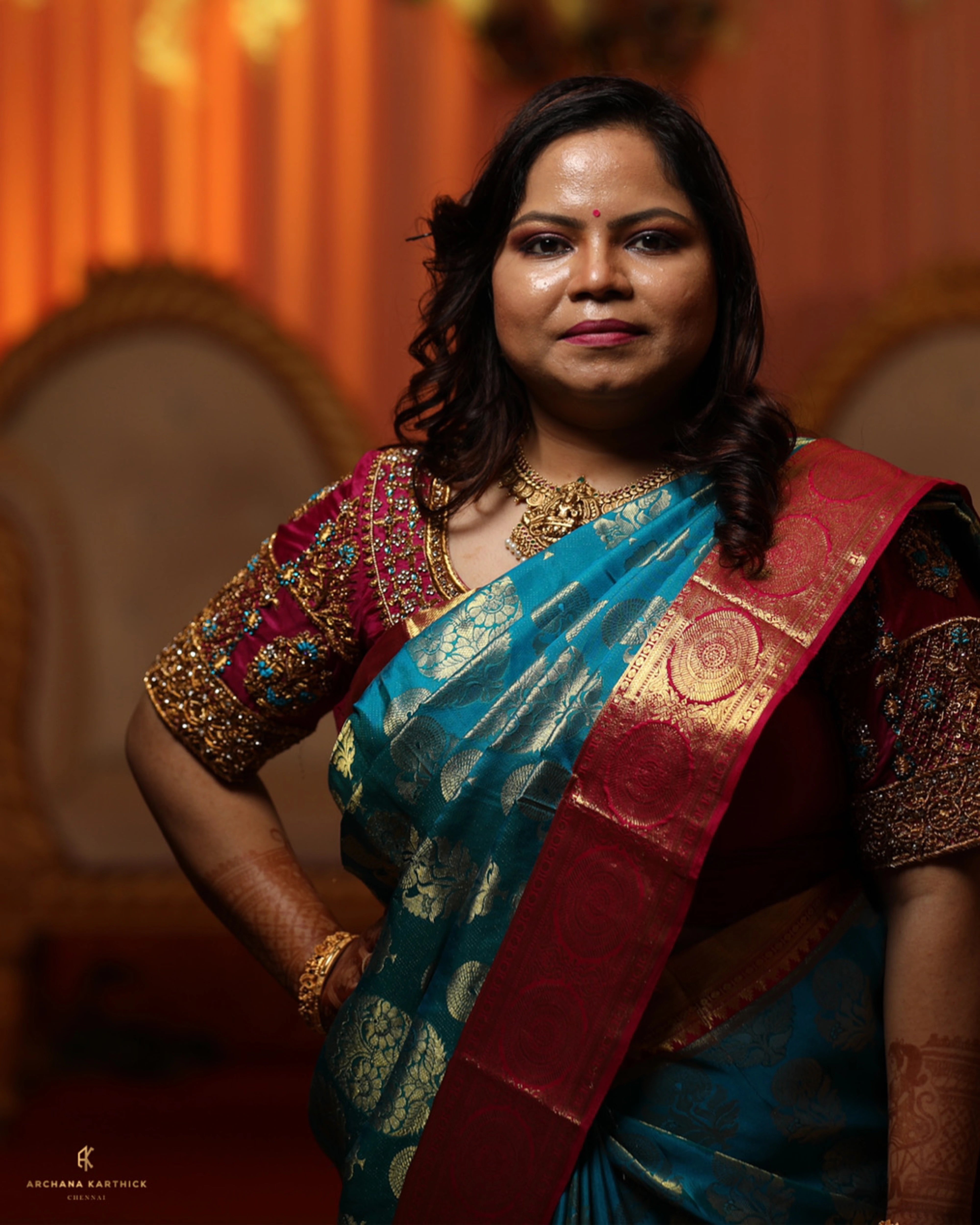 Model Adyasha posing in a magenta silk blouse designed by Archana Karthick