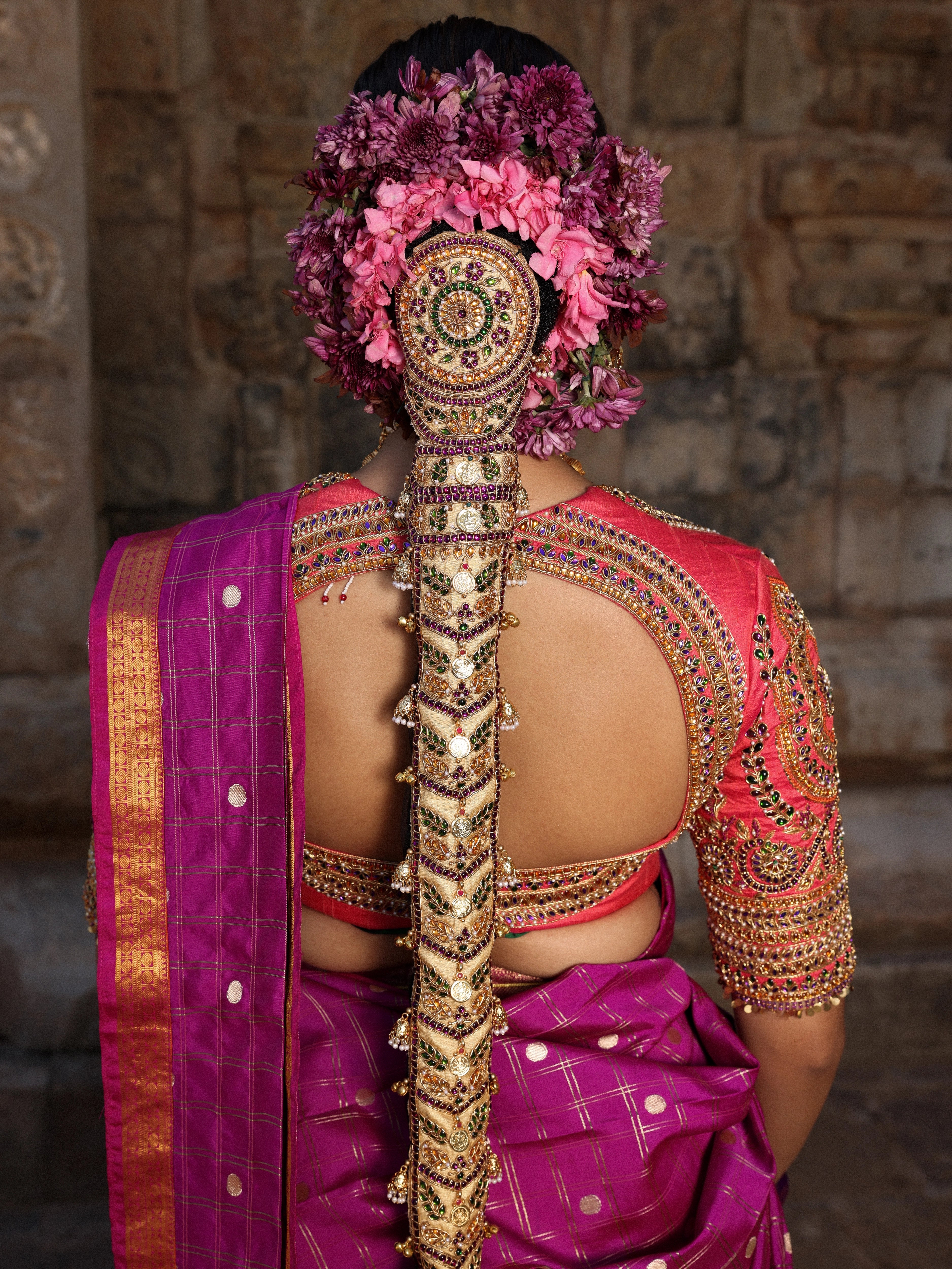 Model Anyuktha Nallani showcasing blouse back & hair braid detailing in pink yellow and purple kanjeevaram silk half saree by chennai-based luxury couture label Archana Karthick