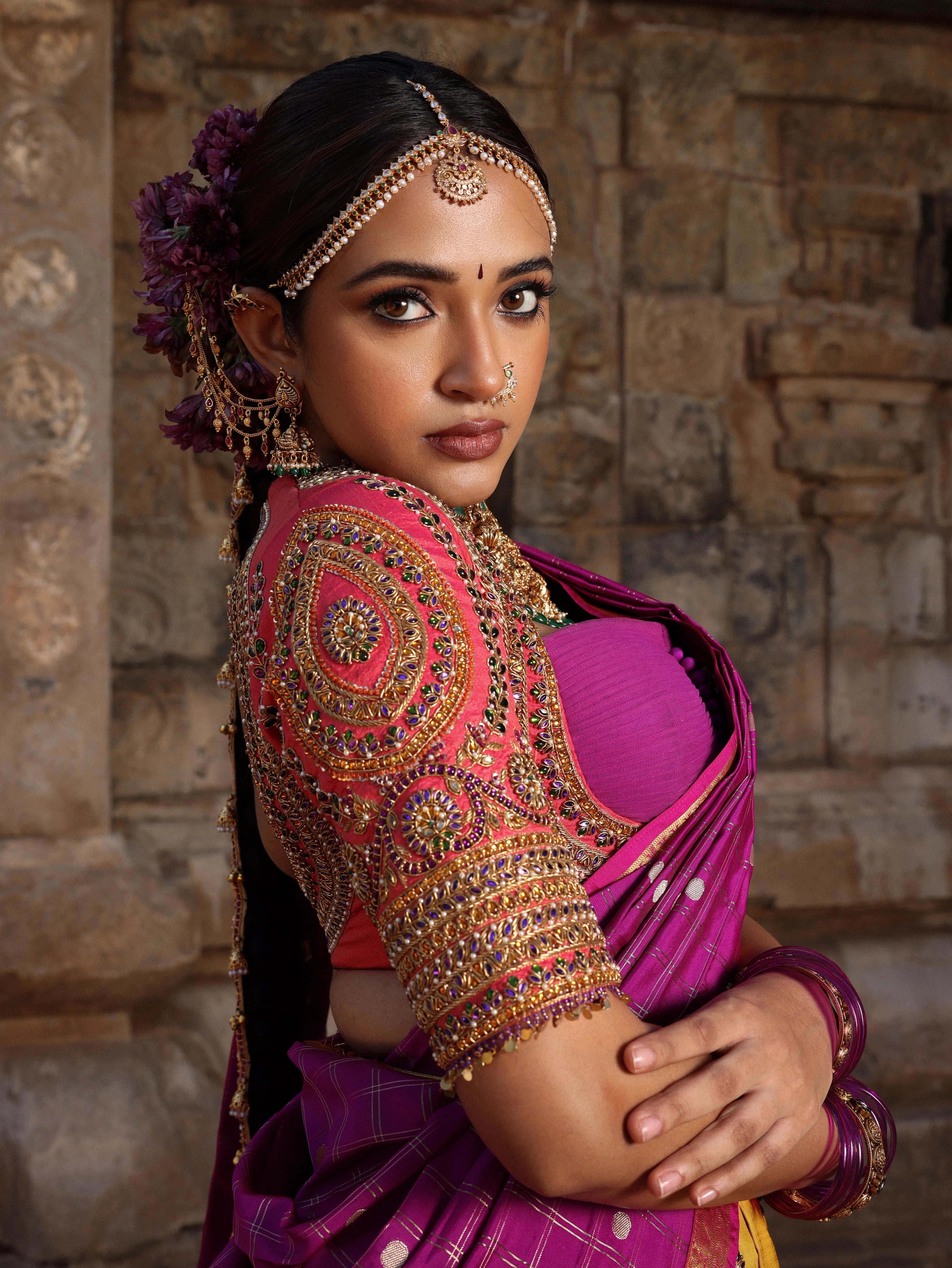 Model Anyuktha Nallani showcasing blouse sleeve design in pink yellow and purple kanjeevaram silk half saree by chennai-based luxury couture label Archana Karthick