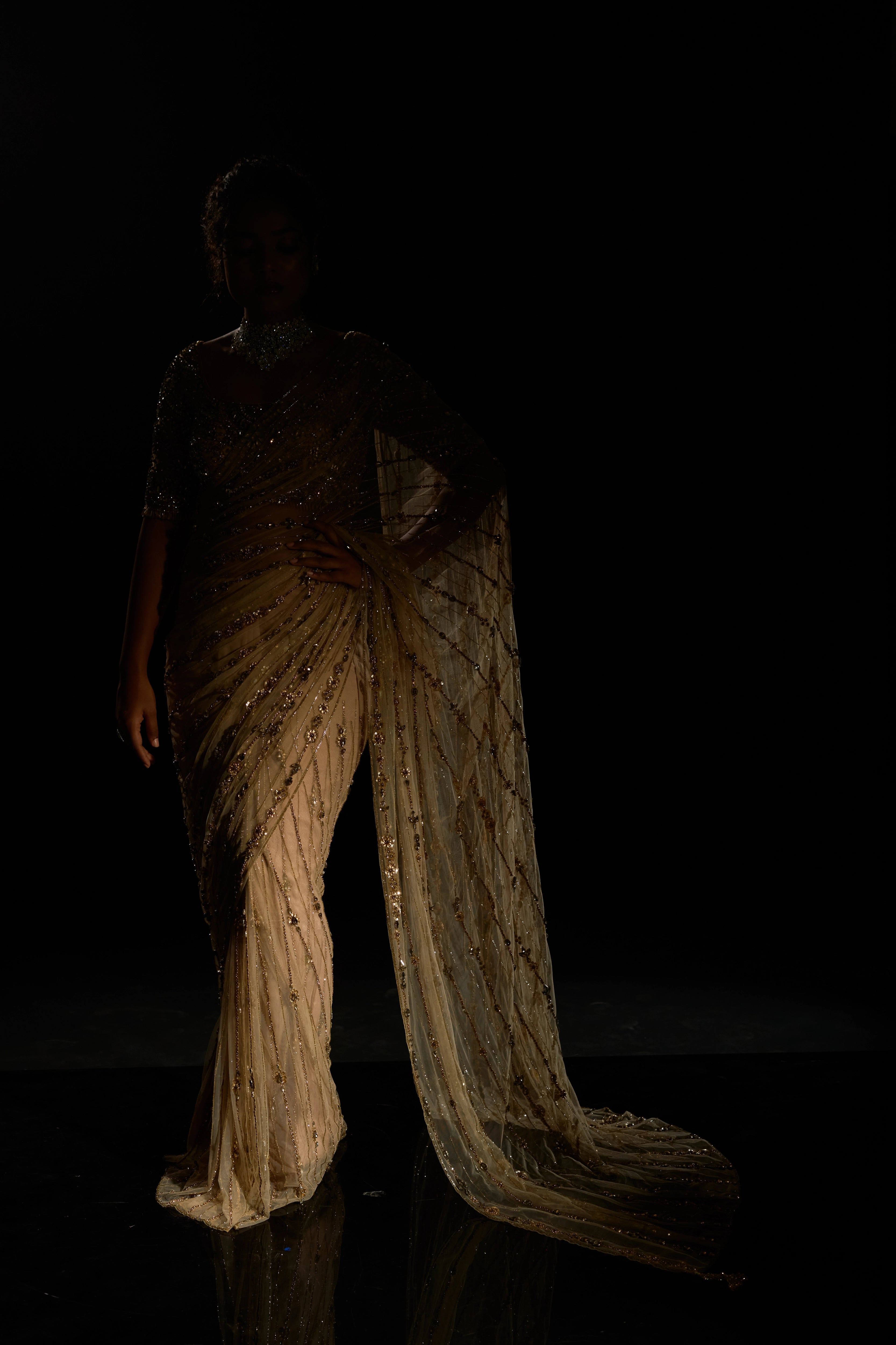 Model Ashika Crystal during a photoshoot in a gold saree set intricately adorned with sequins, rhinestones, crystals and cutdana for "STARDUST" - A/W'25 saree collection by team Archana Karthick.