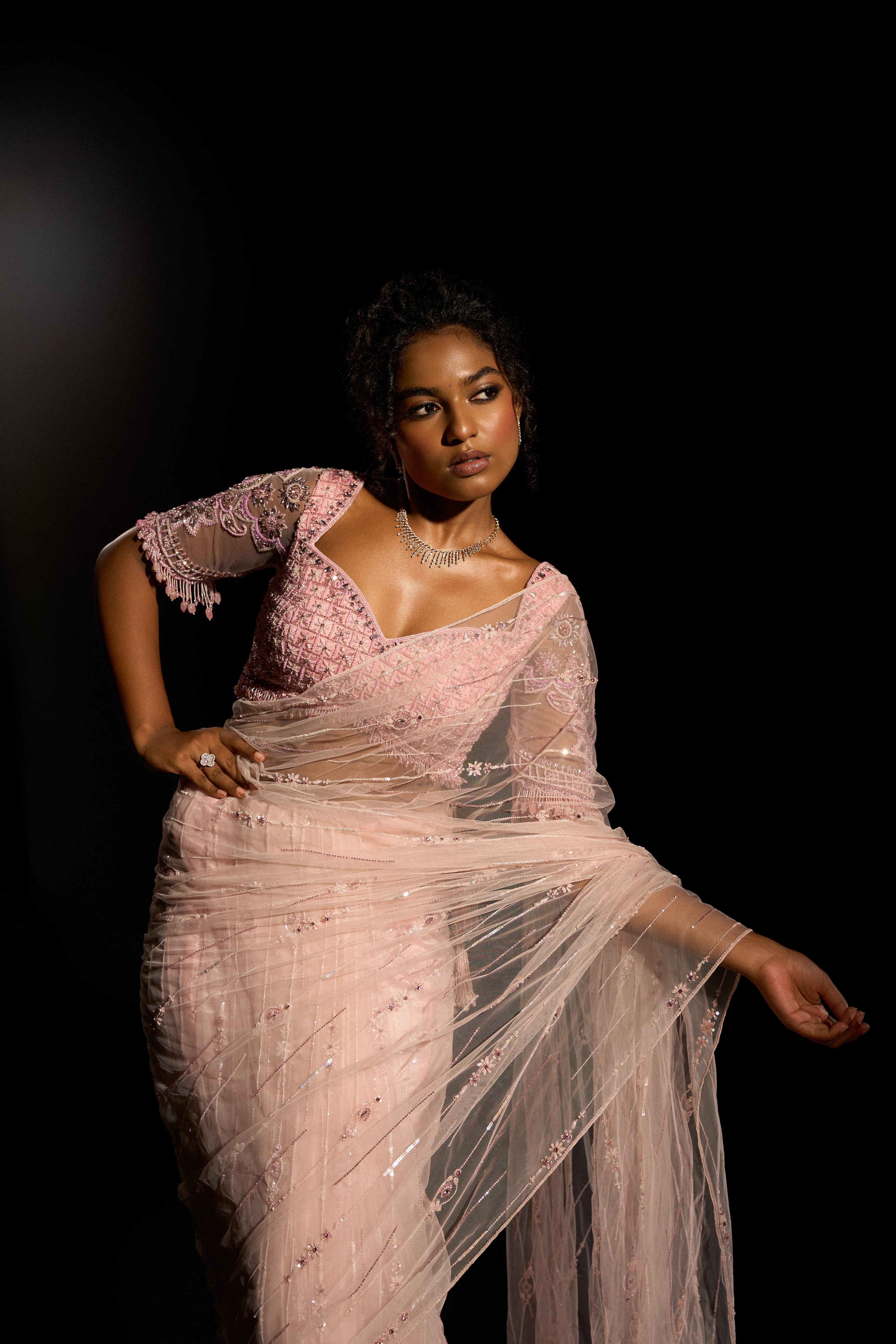 Model Ashika Crystal posing for photoshoot in a blush pink saree set, intricately adorned with sequins, rhinestones, crystals and cutdana for "STARDUST" - A/W'25 saree collection by team Archana Karthick.