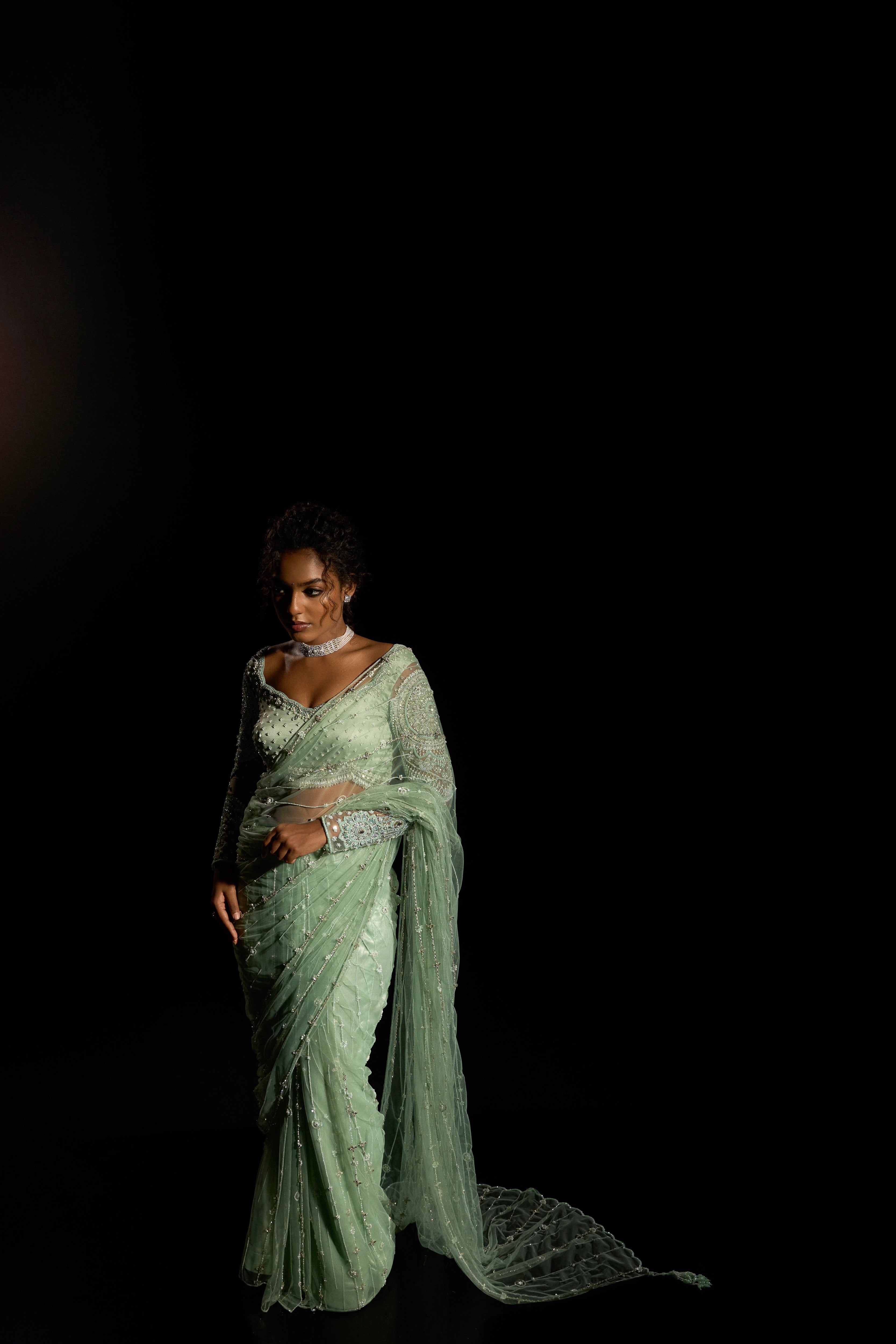 Model Ashika Crystal posing for photoshoot in a green saree set intricately adorned with sequins, rhinestones, crystals and cutdana for "STARDUST" - A/W'25 saree collection by team Archana Karthick.