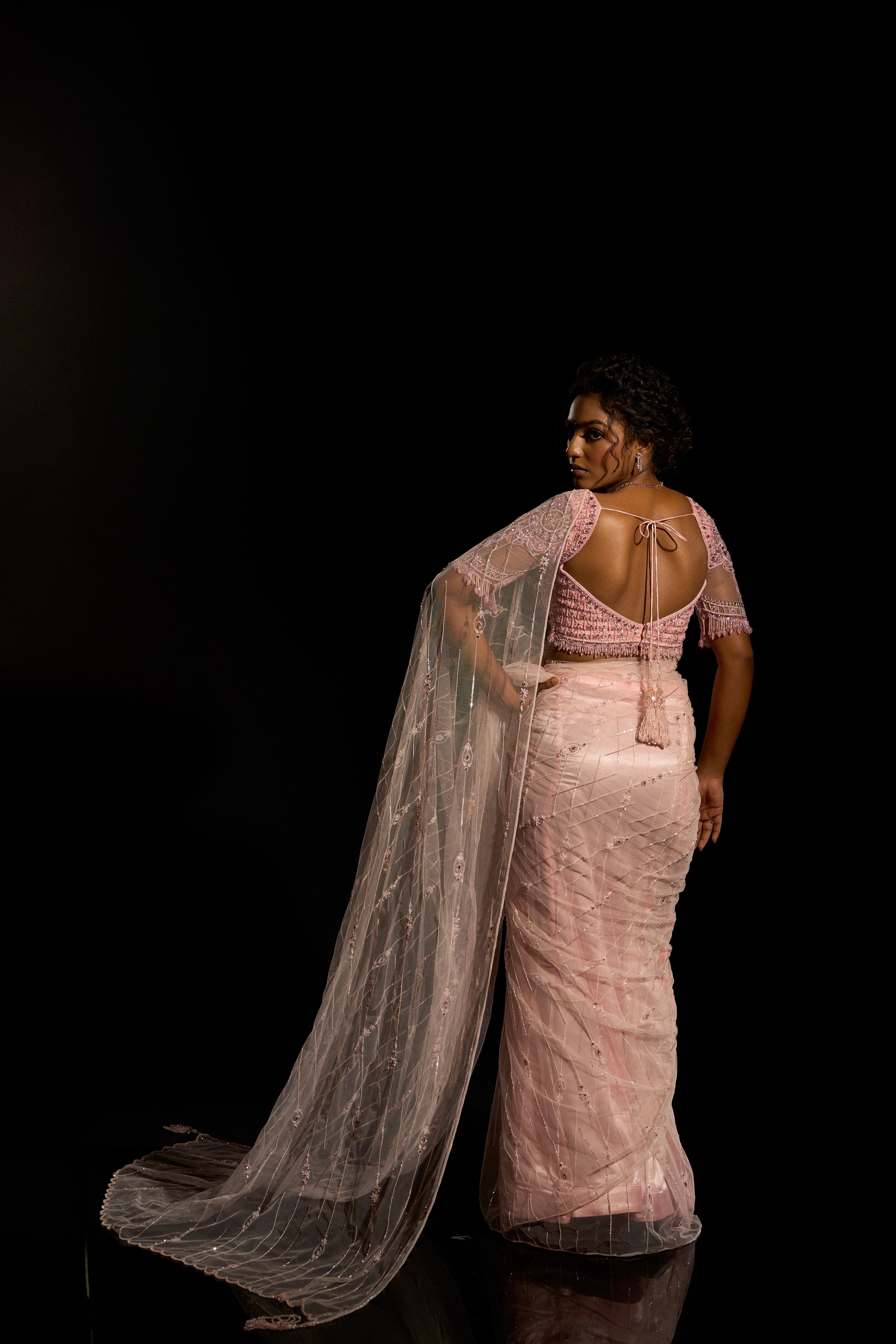 Model Ashika Crystal showcasing full back detailing in a blush pink saree set, intricately adorned with sequins, rhinestones, crystals and cutdana for "STARDUST" - A/W'25 saree collection by team Archana Karthick.