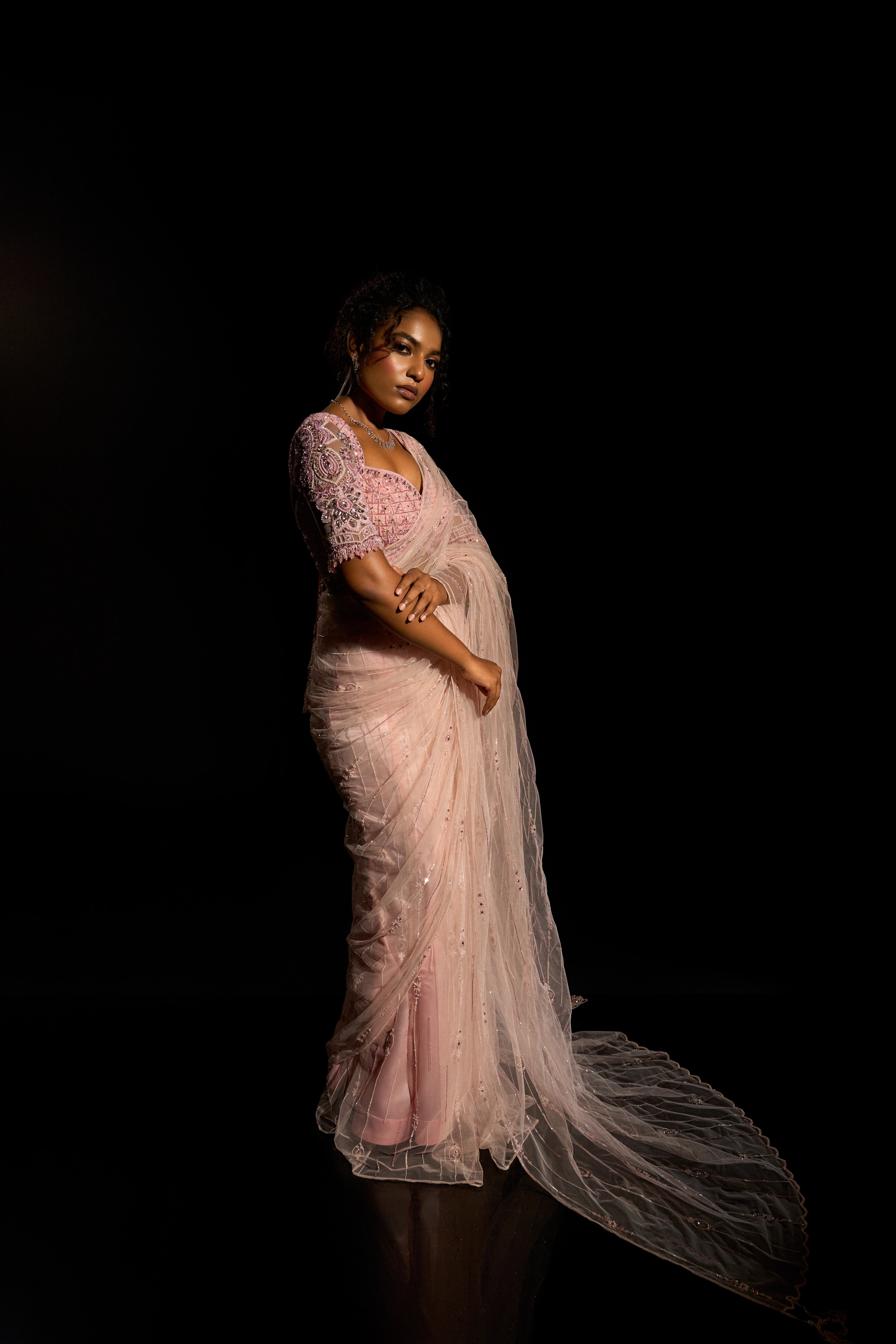 Model Ashika Crystal showcasing full side profile in a blush pink saree set, intricately adorned with sequins, rhinestones, crystals and cutdana for "STARDUST" - A/W'25 saree collection by team Archana Karthick.