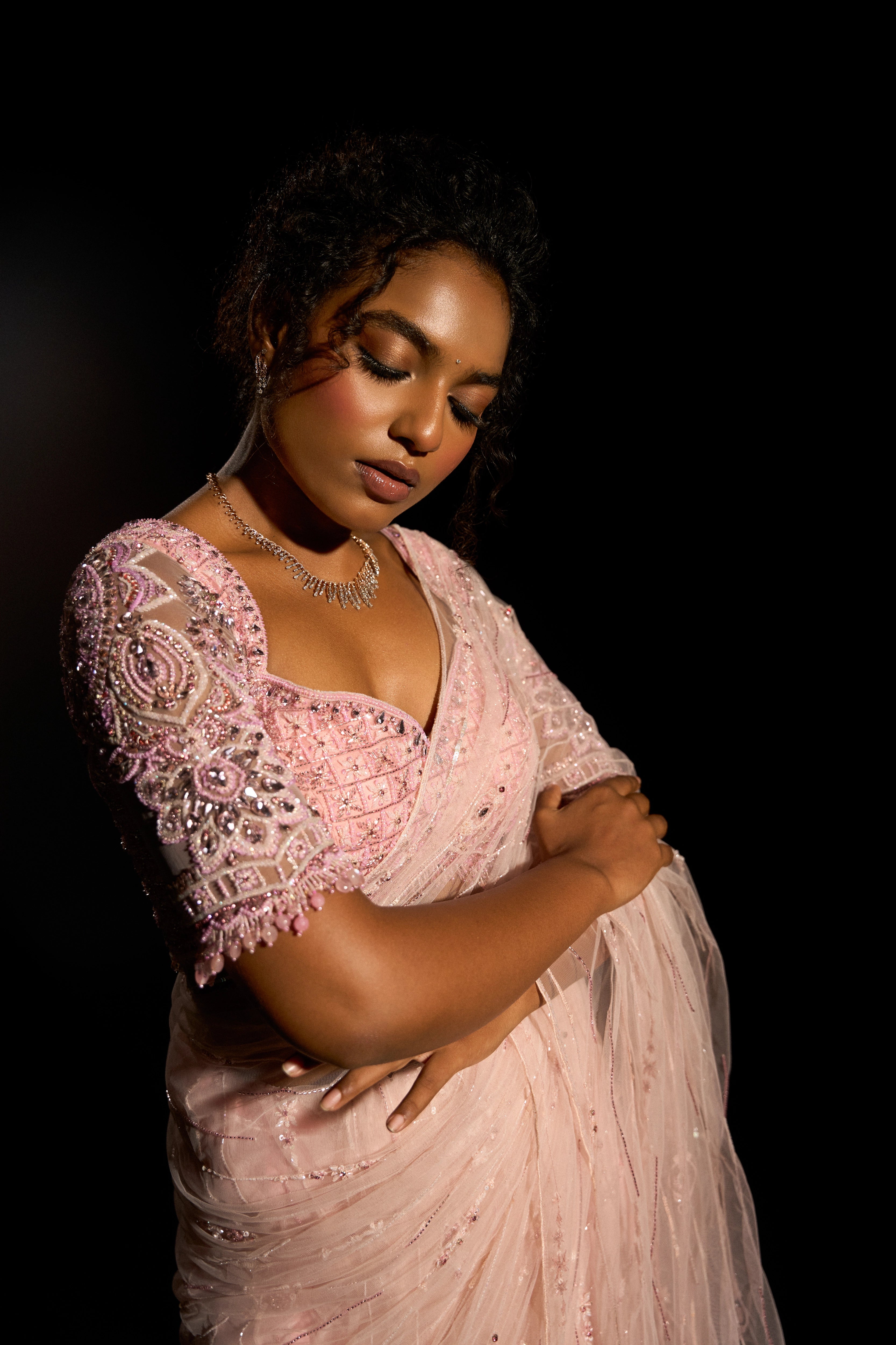 Model Ashika Crystal showcasing sleeve detailing in a blush pink saree set, intricately adorned with sequins, rhinestones, crystals and cutdana for "STARDUST" - A/W'25 saree collection by team Archana Karthick.