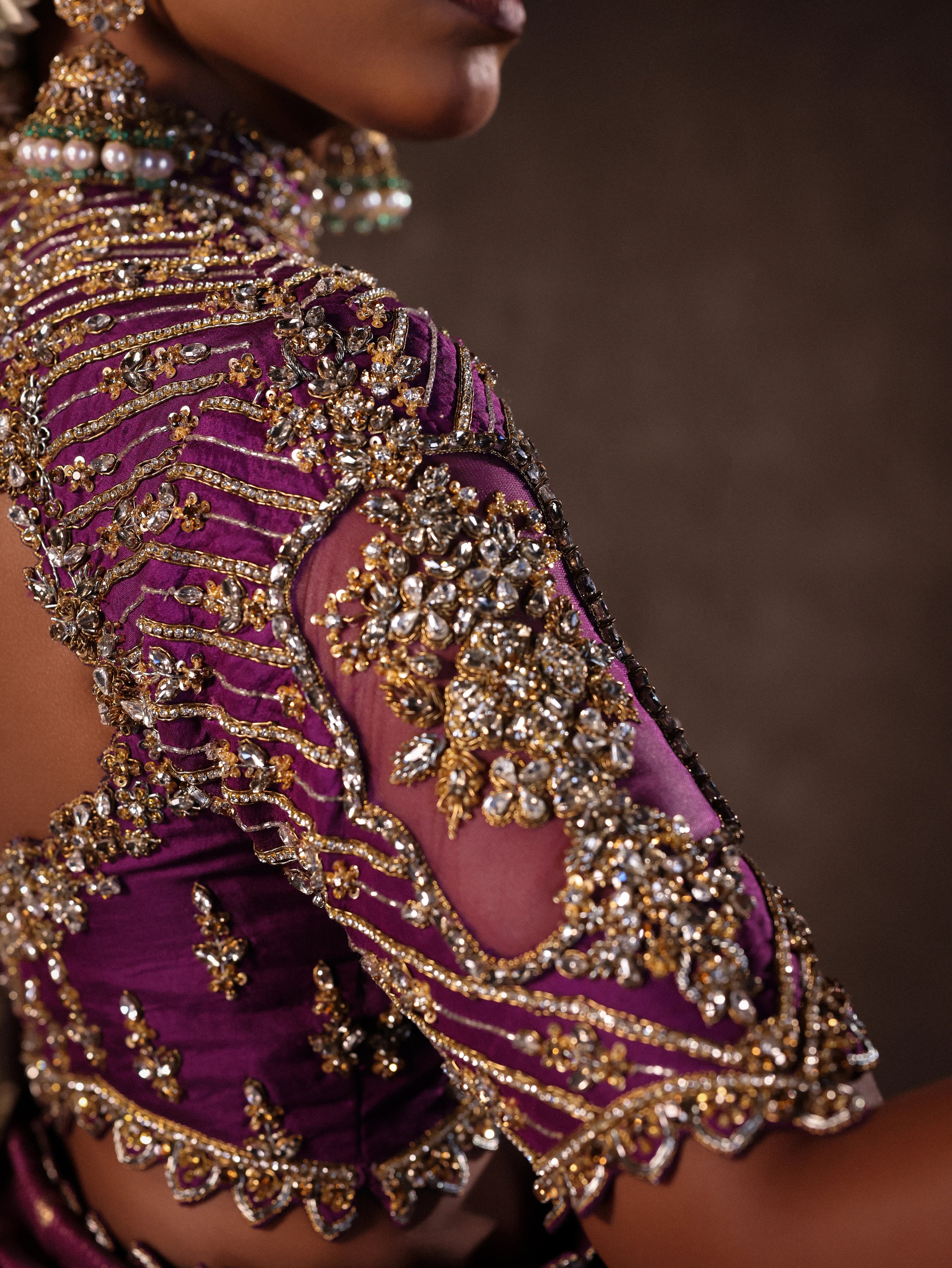 Model Ashika Crystal showcasing sleeve detailing in a silk half saree set in purple, handcrafted with zardozi, sequins and rhinestones. Team Archana Karthick completed the style with purple glass bangles, a ring, jhumkas, nose ring and a maang tikka.