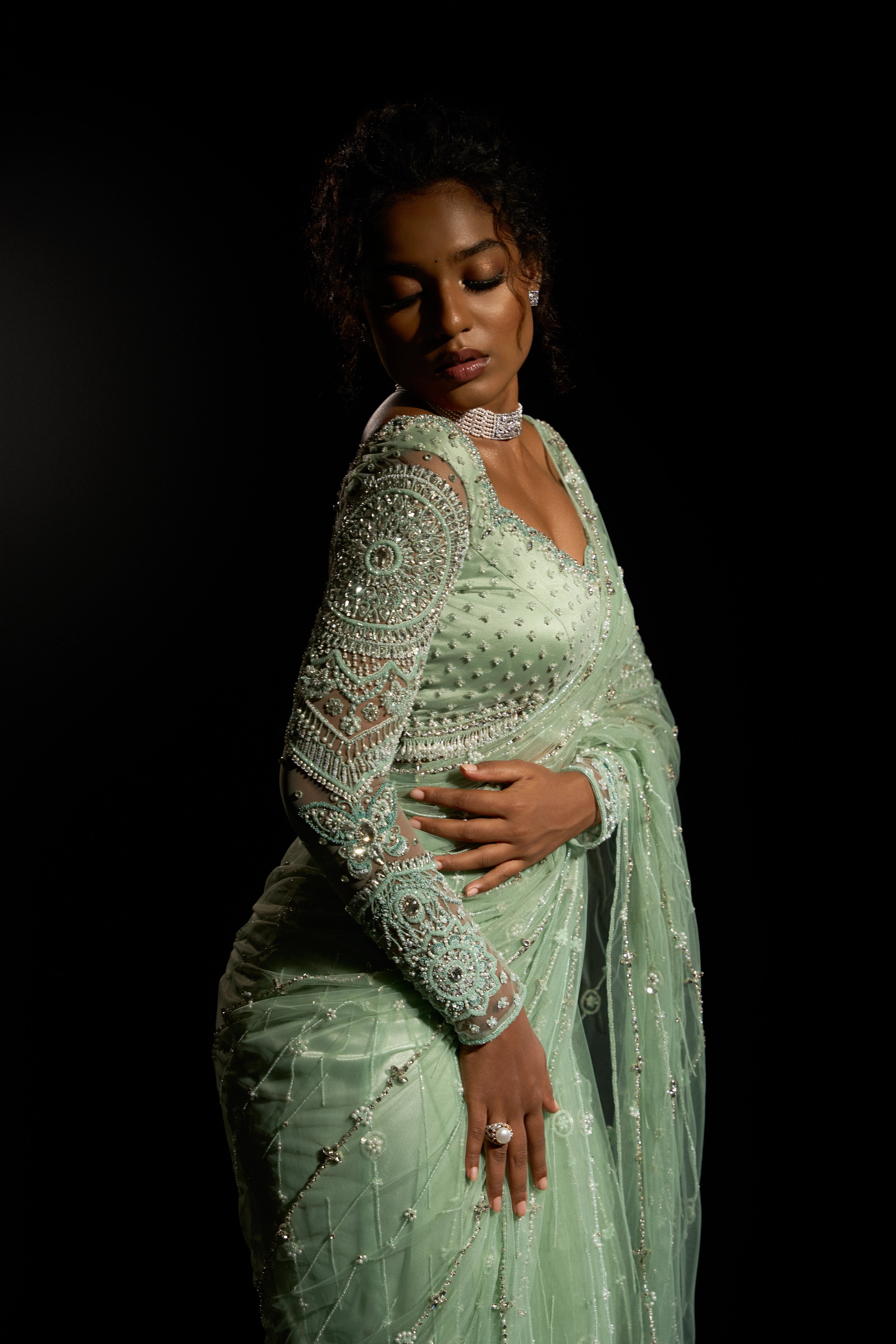 Model Ashika Crystal showcasing the sleeve detailing in a green saree set intricately adorned with sequins, rhinestones, crystals and cutdana for "STARDUST" - A/W'25 saree collection by team Archana Karthick.