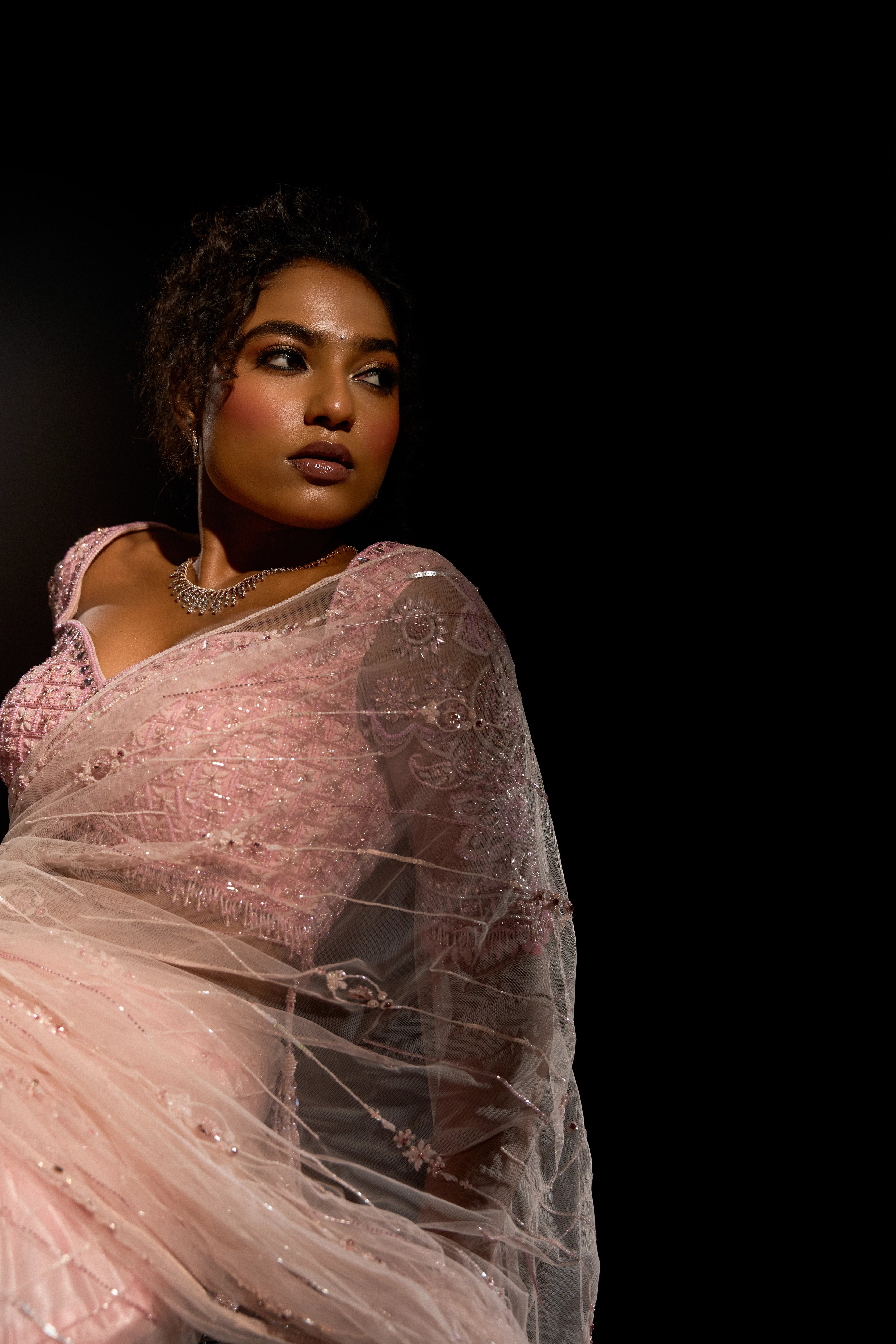Model Ashika Crystal striking a pose in a blush pink saree set, intricately adorned with sequins, rhinestones, crystals and cutdana for "STARDUST" - A/W'25 saree collection by team Archana Karthick.