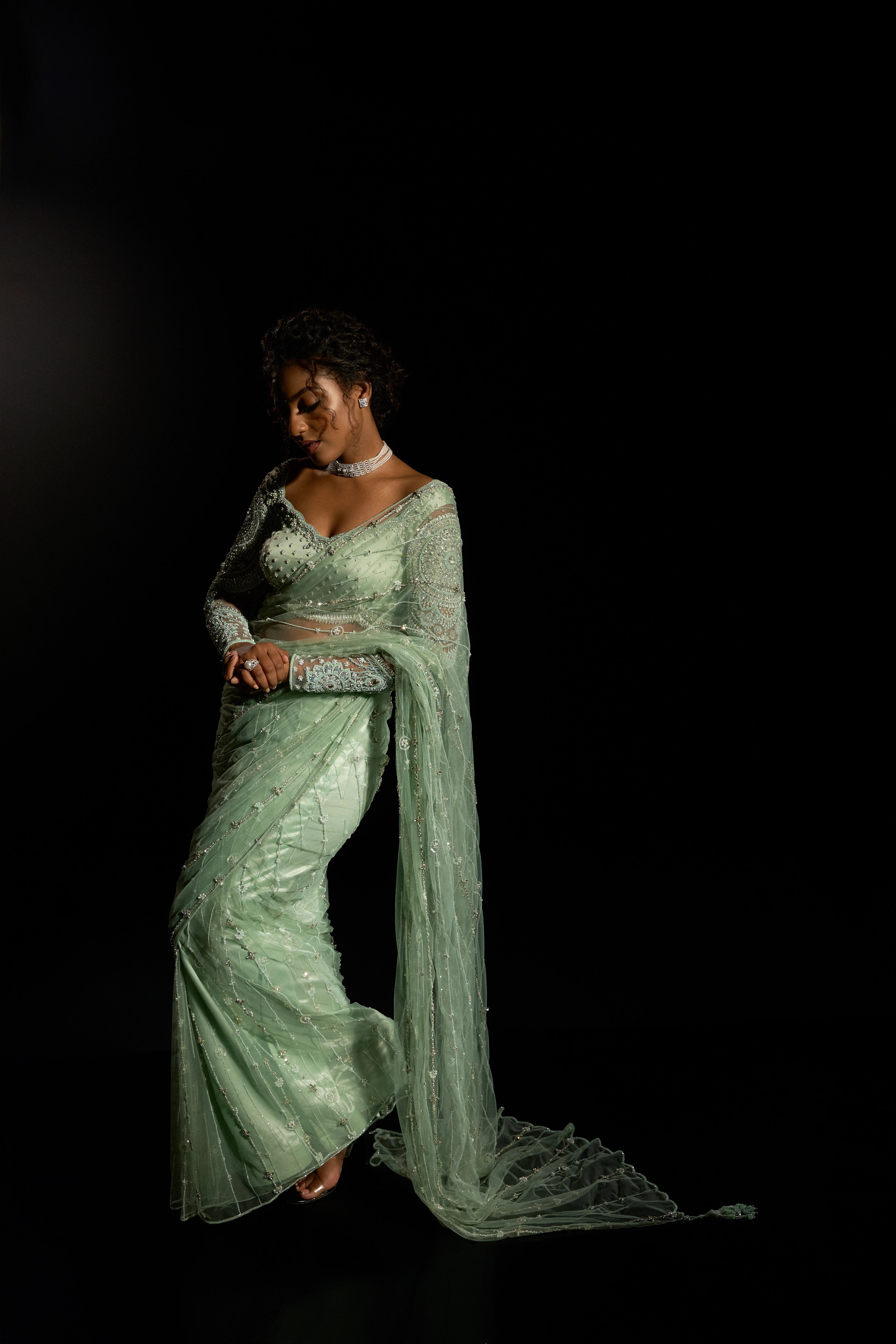 Model Ashika Crystal striking a pose in a green saree set intricately adorned with sequins, rhinestones, crystals and cutdana for "STARDUST" - A/W'25 saree collection by team Archana Karthick.