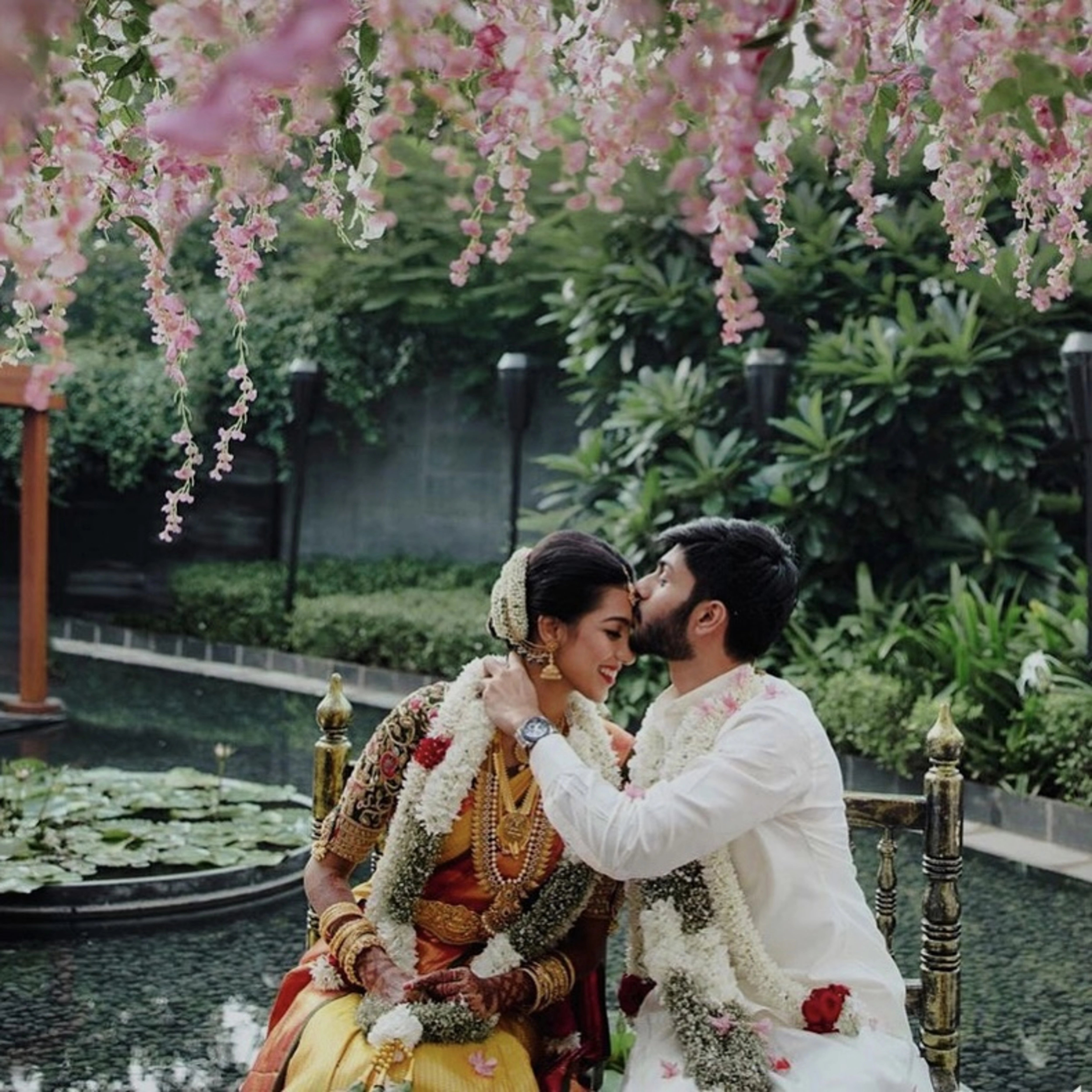 Model Ashwini Kumar in a green silk blouse during her wedding with Kavin Venkatesh of Maybell, handcrafted intricately with stones, pearls, zardozi, beads, zari and knot work by team Archana Karthick.