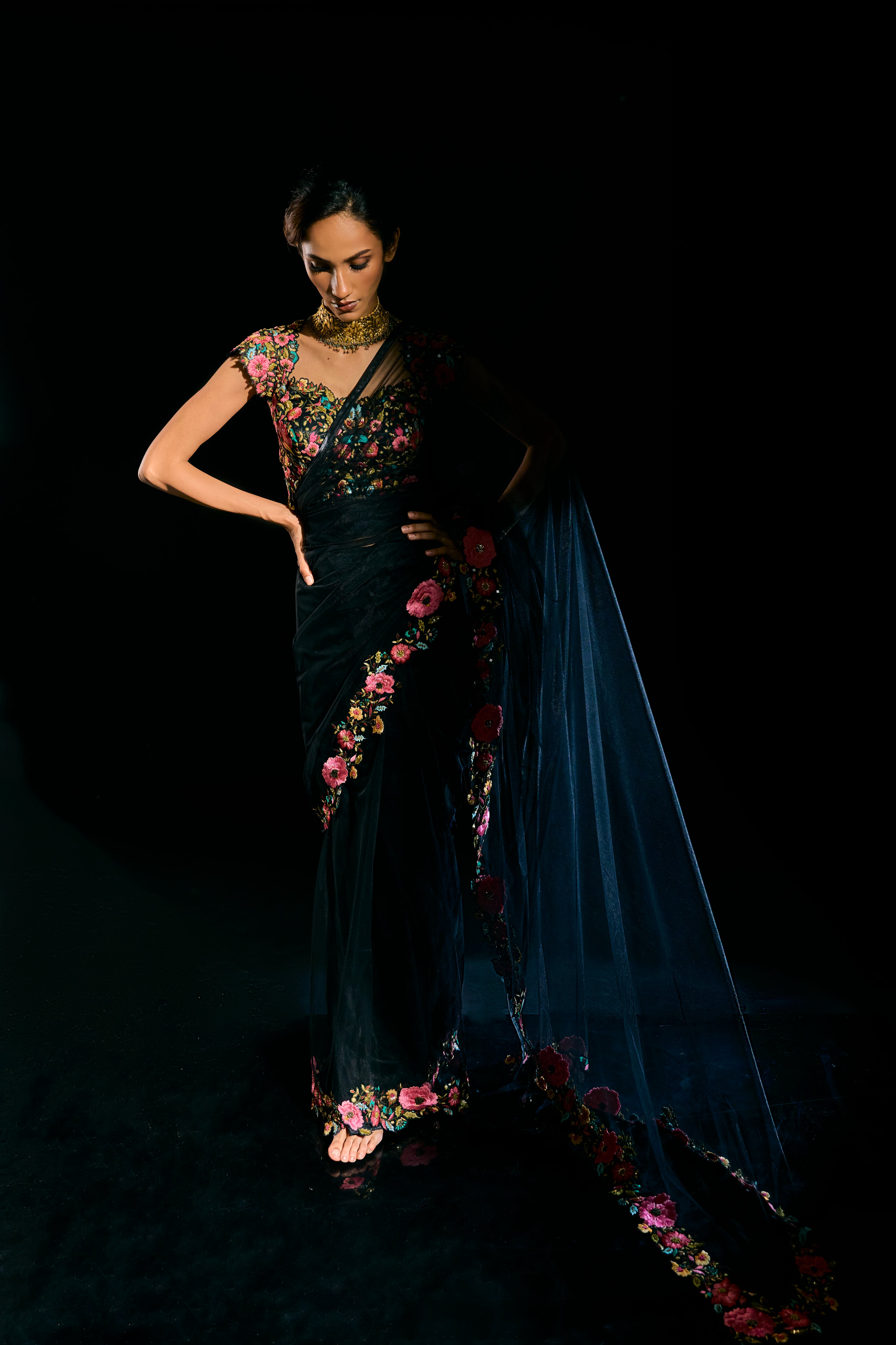 Model Esha Gohil draped in black tulle and embroidered with floral resham that gleam like whispers in the dark. Handcrafted for "HAZE" - A/W'25 capsule collection by Archana Karthick.