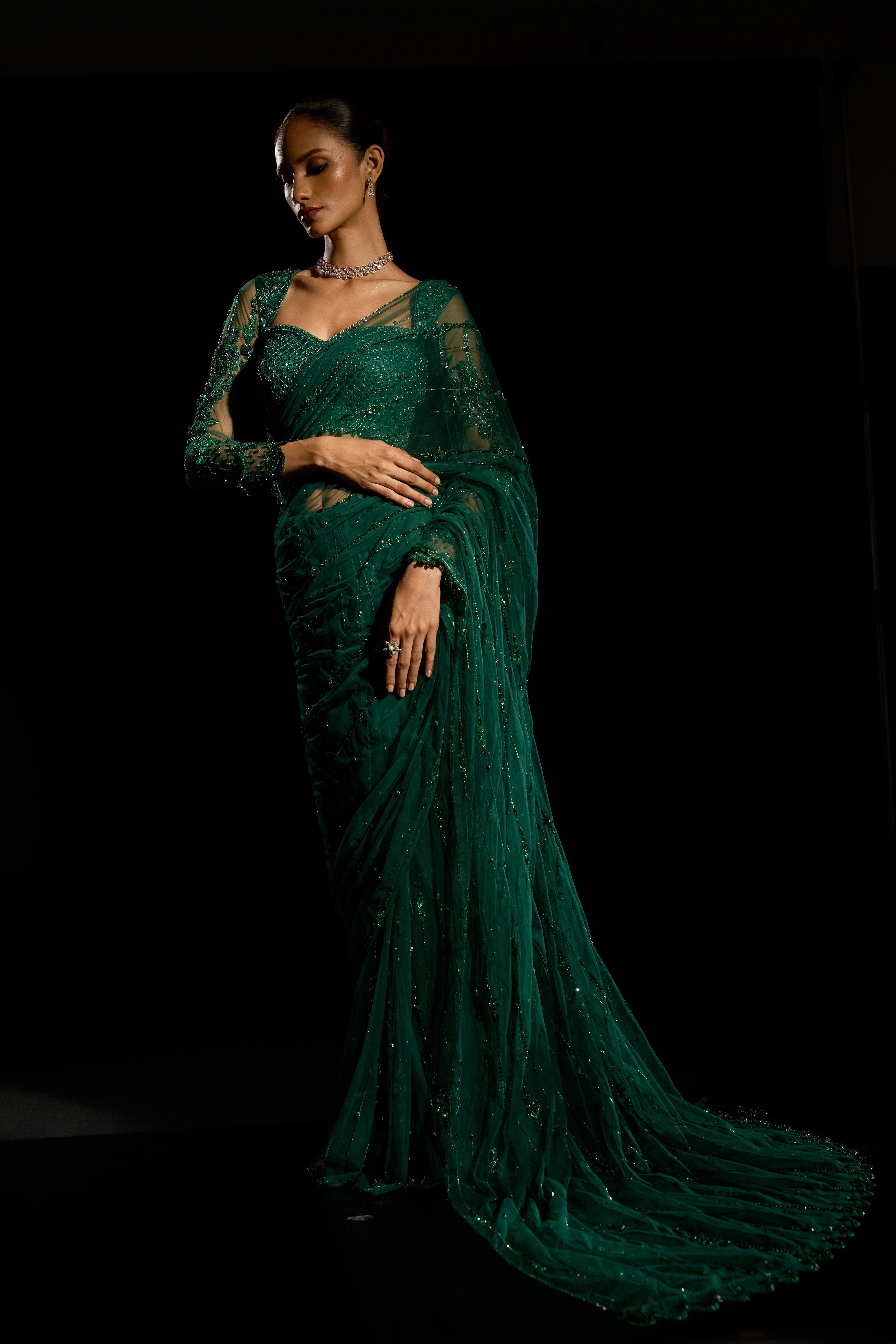 Model Esha Gohil in a bottle green saree set is intricately adorned with sequins, rhinestones, crystals and cutdana for "STARDUST" - A/W'25 saree collection by team Archana Karthick.