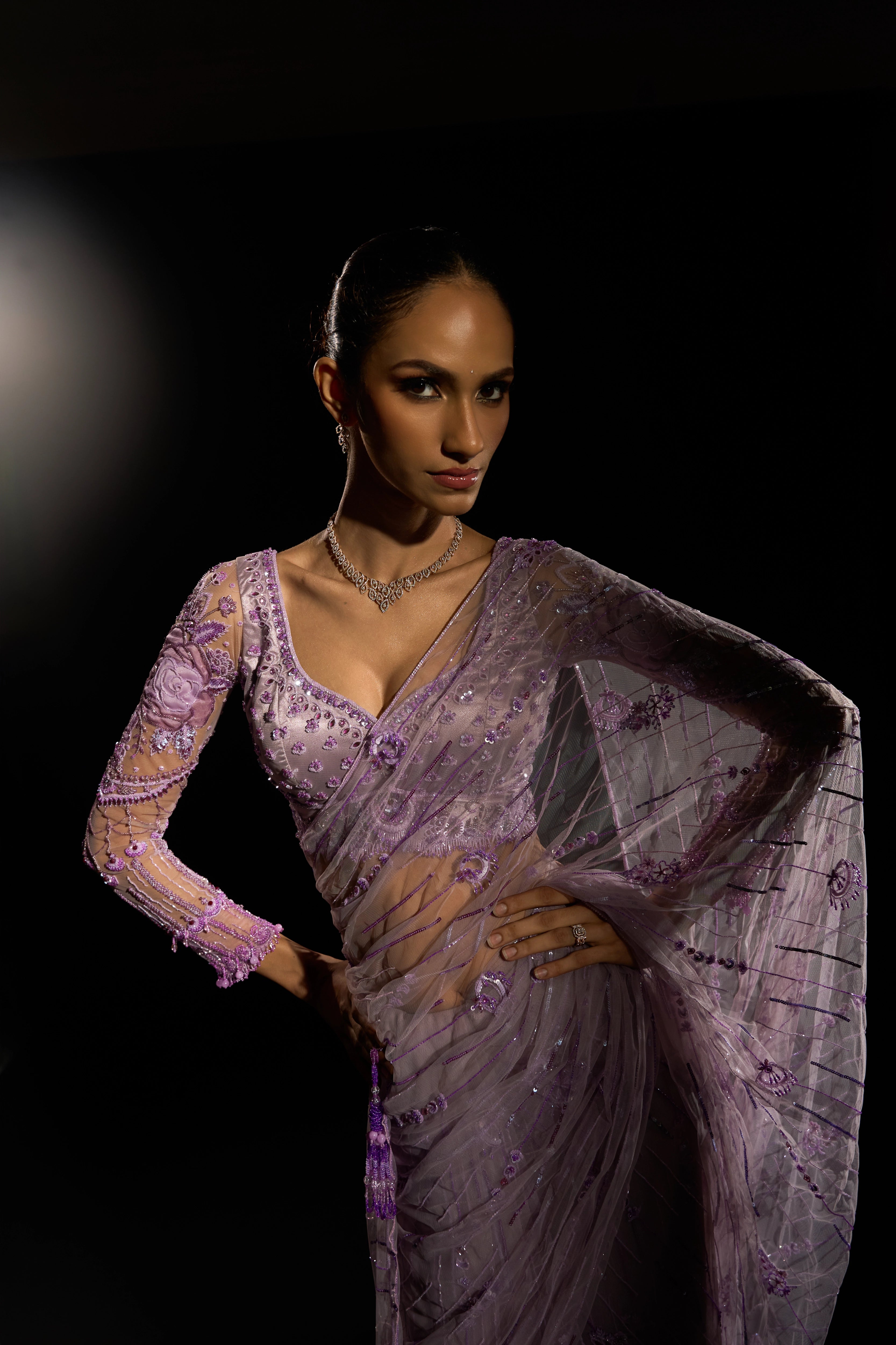 Model Esha Gohil posing for front design in a lavender saree set intricately adorned with sequins, rhinestones, crystals and cutdana for "STARDUST" - A/W'25 saree collection by team Archana Karthick.