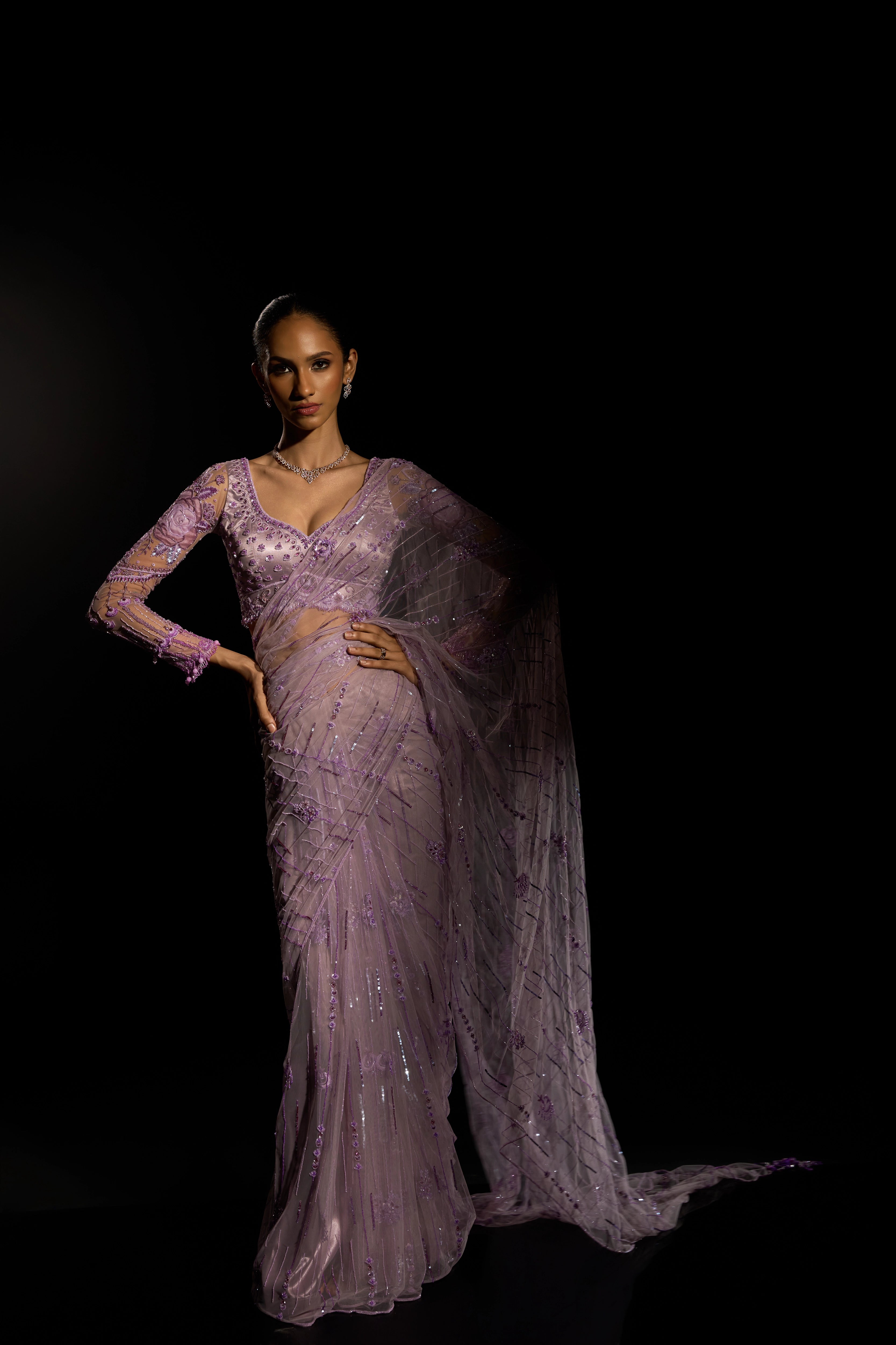 Model Esha Gohil posing in a lavender saree set intricately adorned with sequins, rhinestones, crystals and cutdana for "STARDUST" - A/W'25 saree collection by team Archana Karthick.