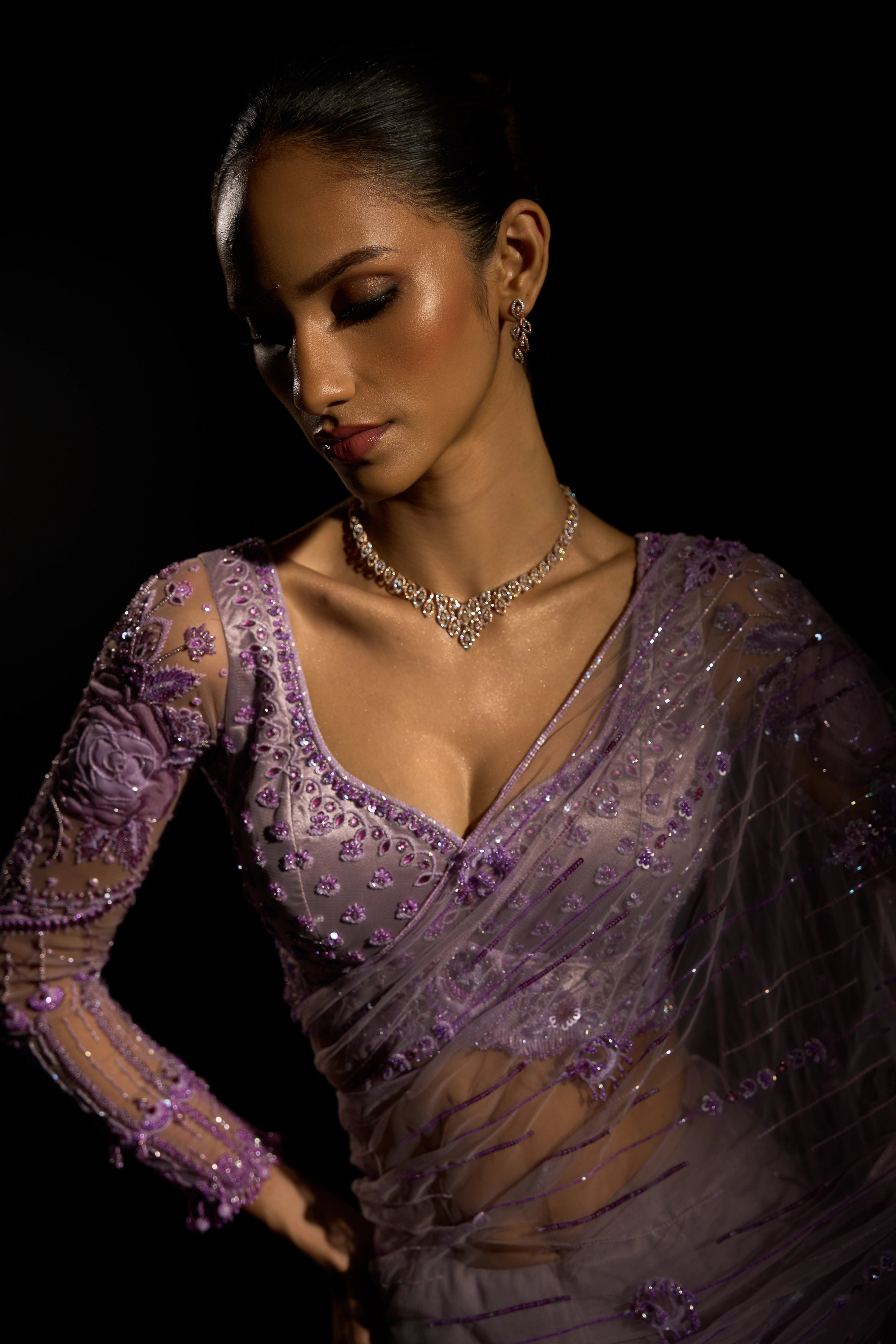 Model Esha Gohil showcases front blouse and sleeve design in a lavender saree set intricately adorned with sequins, rhinestones, crystals and cutdana for "STARDUST" - A/W'25 saree collection by team Archana Karthick.