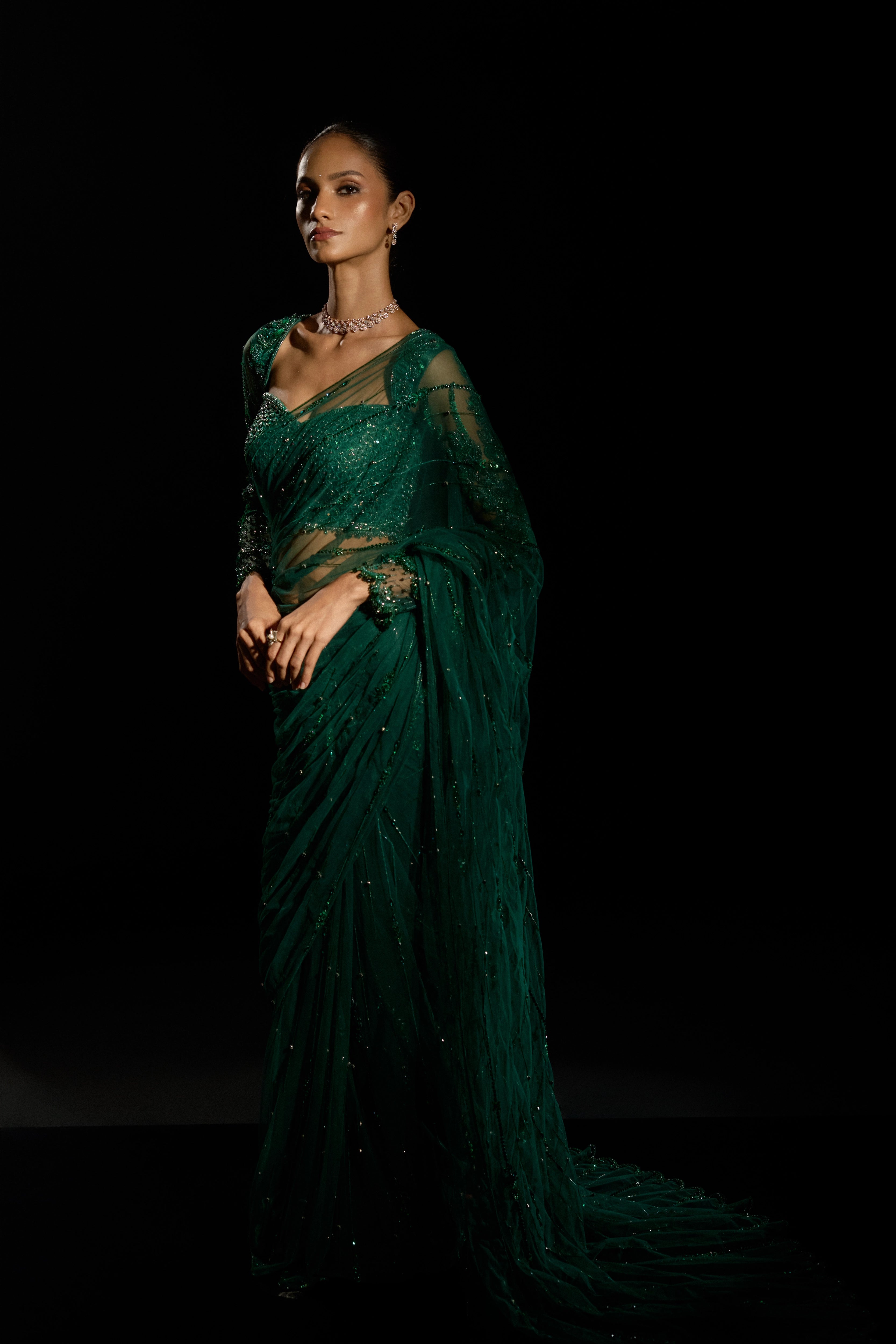Model Esha Gohil showcasing the full profile in a bottle green saree set is intricately adorned with sequins, rhinestones, crystals and cutdana for "STARDUST" - A/W'25 saree collection by team Archana Karthick.
