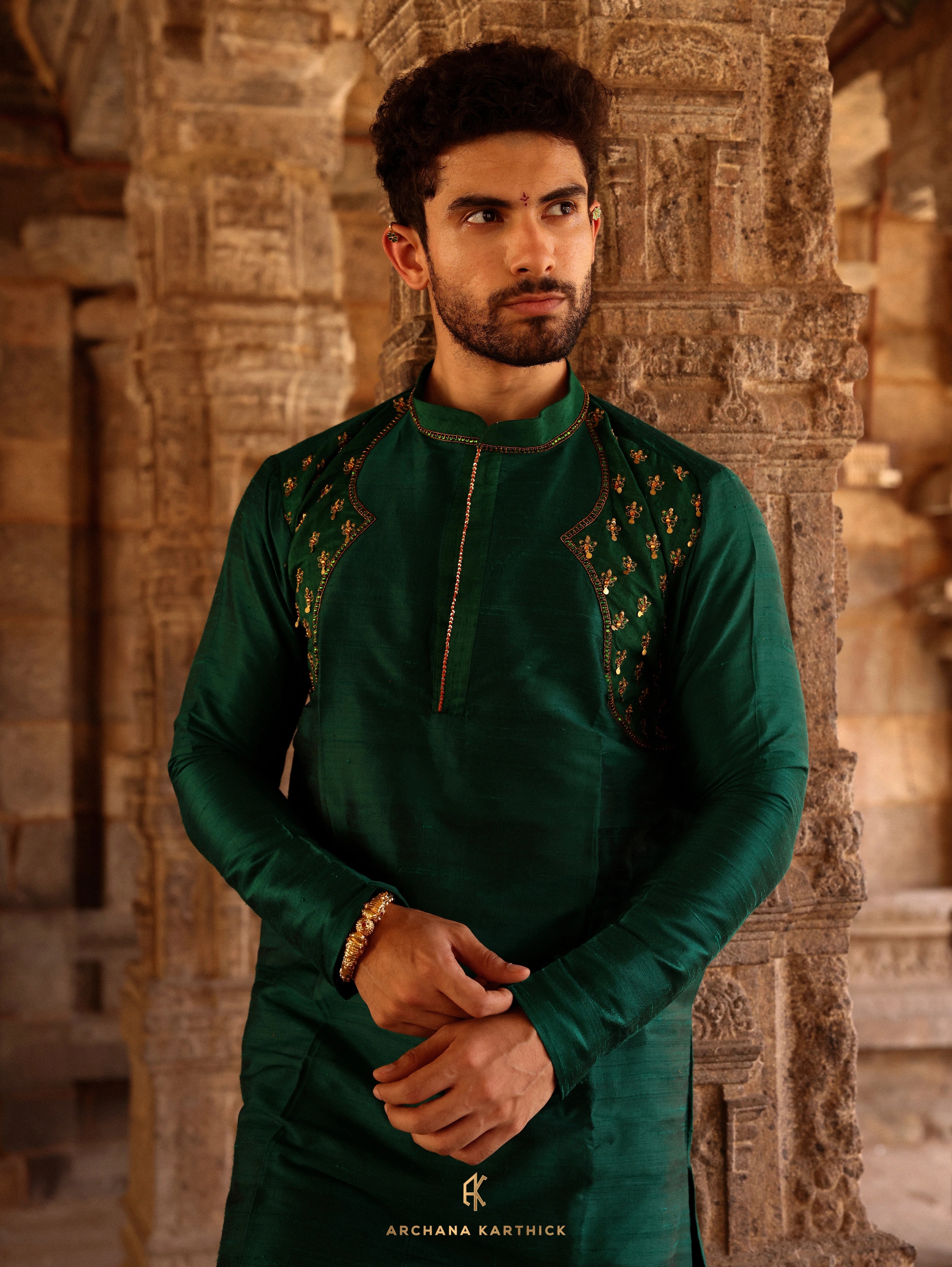 Model Harsh Kapoor posing for photoshoot in green raw silk mens kurta set by chennai-based luxury couture label Archana Karthick