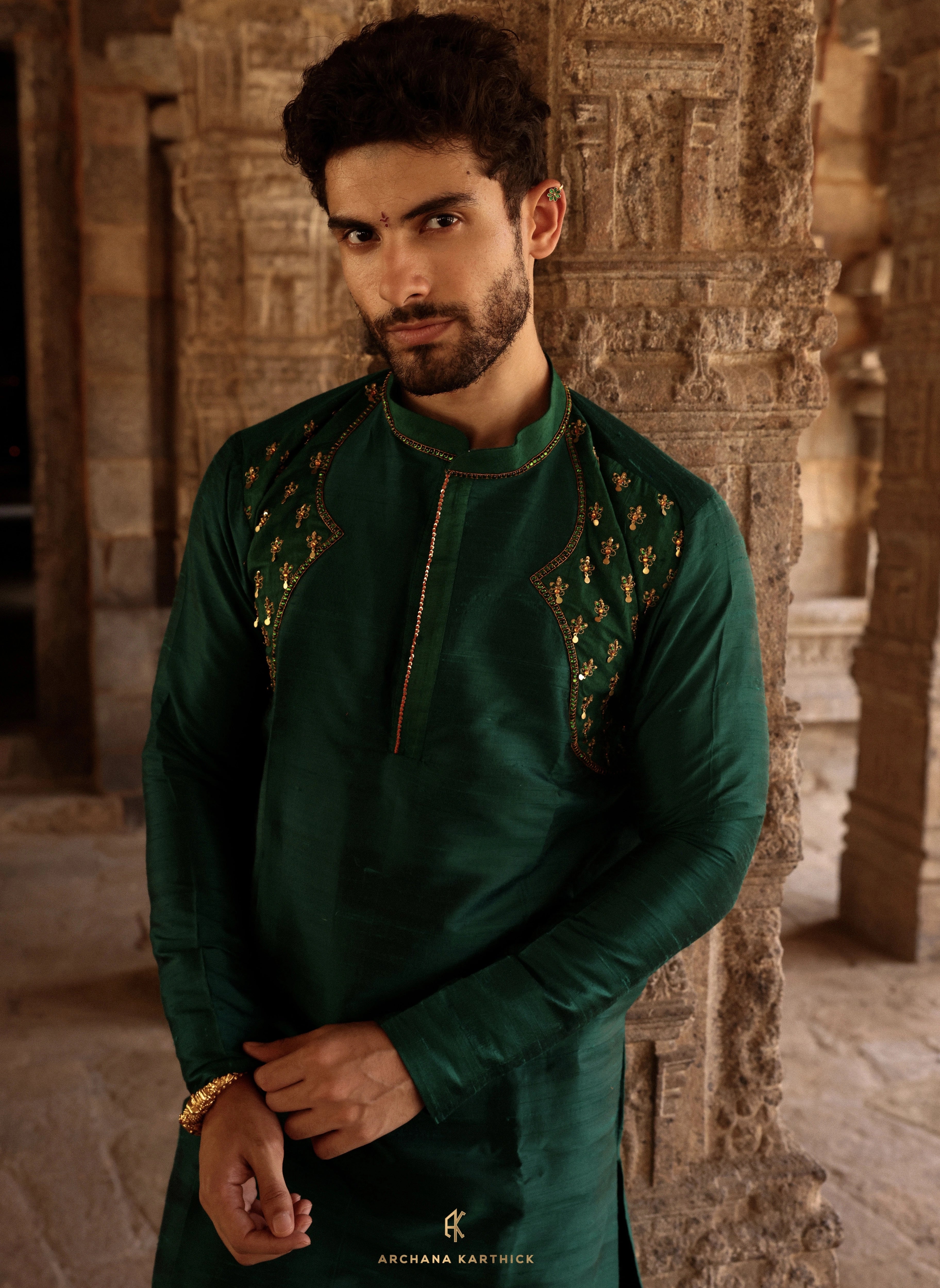 Model Harsh Kapoor showcasing kurta embroidery detailing in green raw silk mens kurta set by chennai-based luxury couture label Archana Karthick