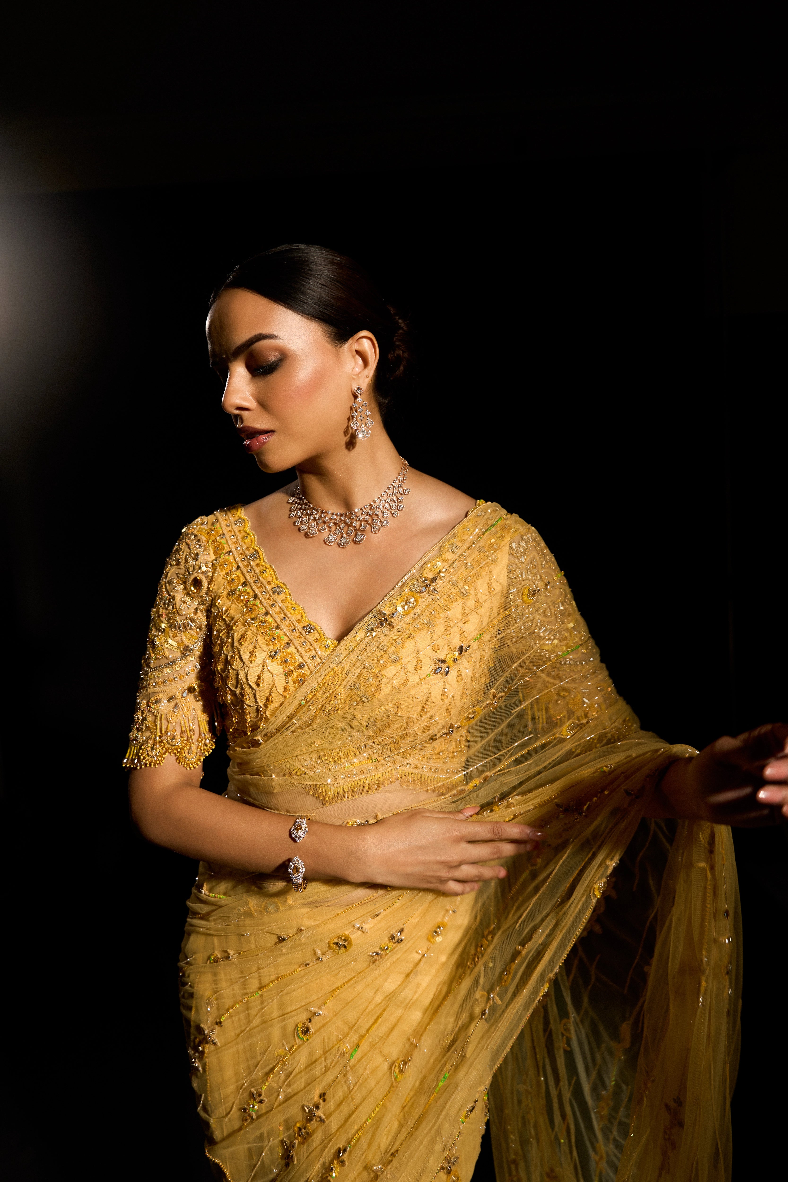 Model Jane C Thompson posing for front profile in a yellow saree set intricately adorned with sequins, rhinestones, crystals and cutdana for "STARDUST" - A/W'25 saree collection by team Archana Karthick.