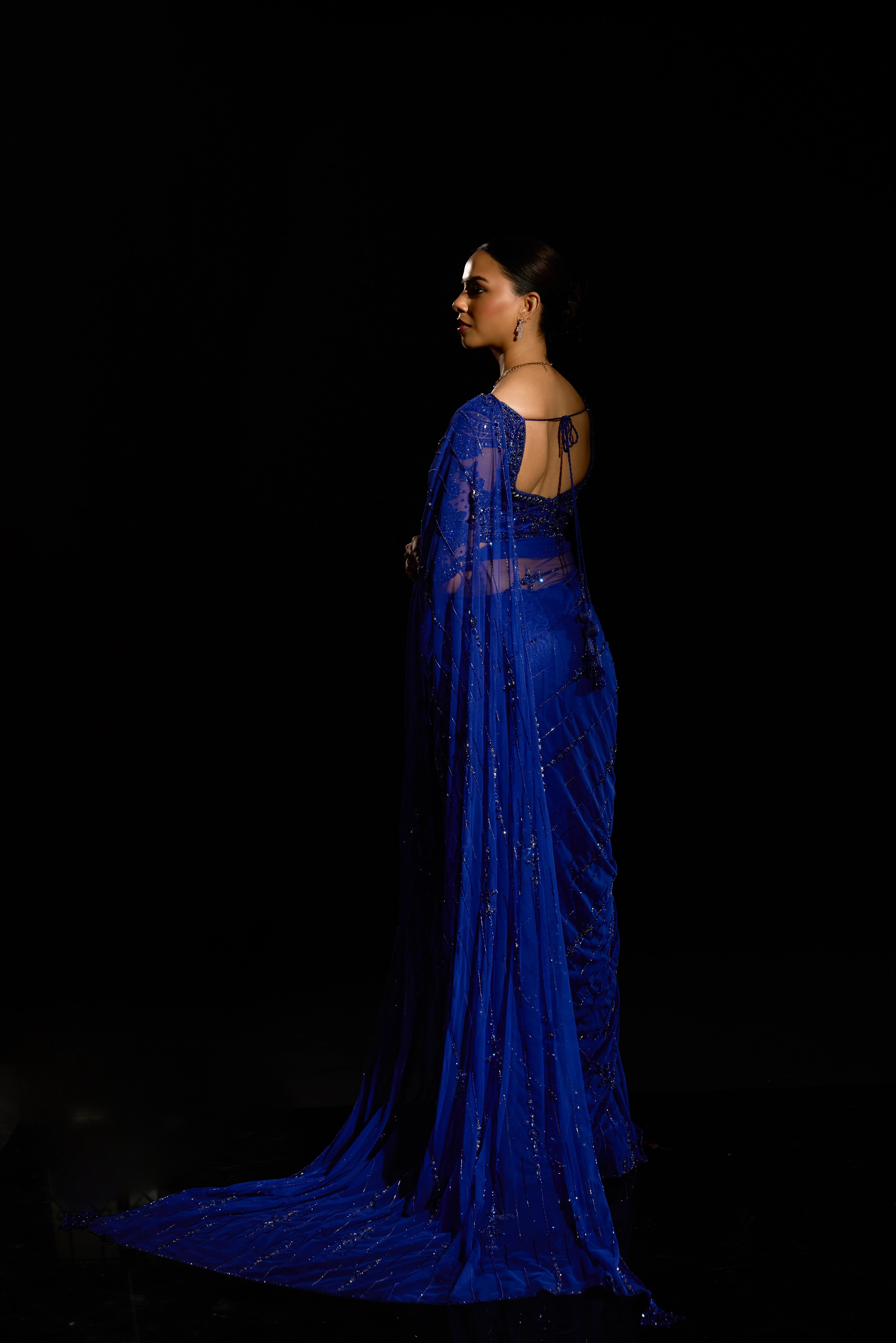 Model Jane C Thompson showcasing full back profile in a sapphire blue saree set intricately adorned with sequins, rhinestones, crystals and cutdana for "STARDUST" - A/W'25 saree collection by team Archana Karthick.
