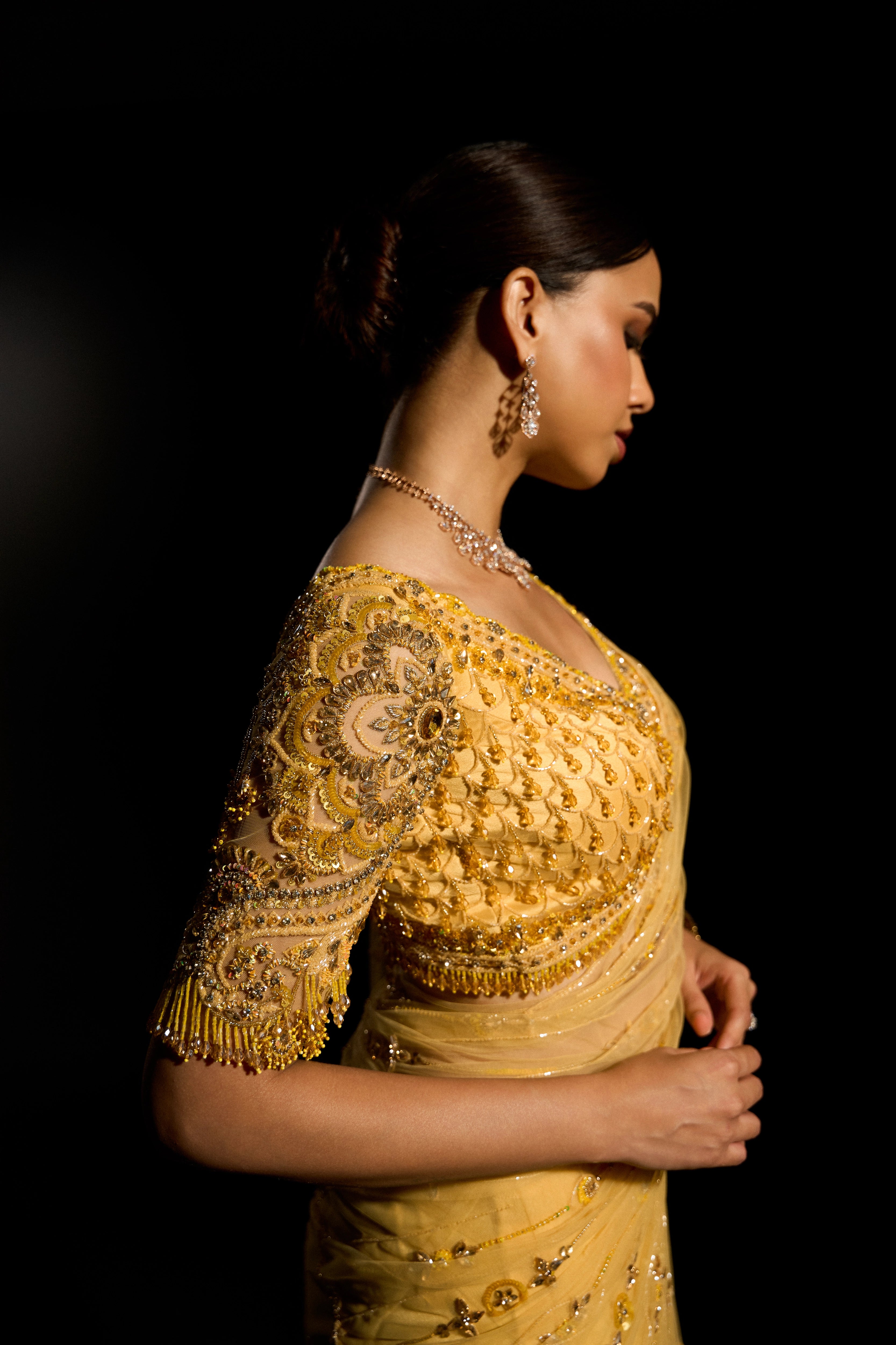 Model Jane C Thompson showcasing sleeve in a yellow saree set intricately adorned with sequins, rhinestones, crystals and cutdana for "STARDUST" - A/W'25 saree collection by team Archana Karthick.