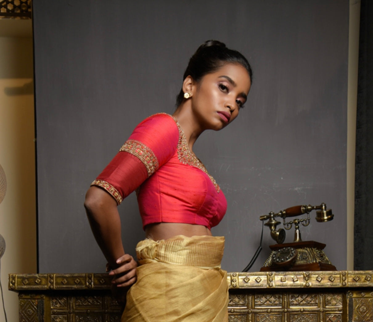 Model Pravallika Prasanna Raju in a red raw silk blouse, intricately handcrafted with pearls, zardozi, stones and zari by team Archana Karthick.