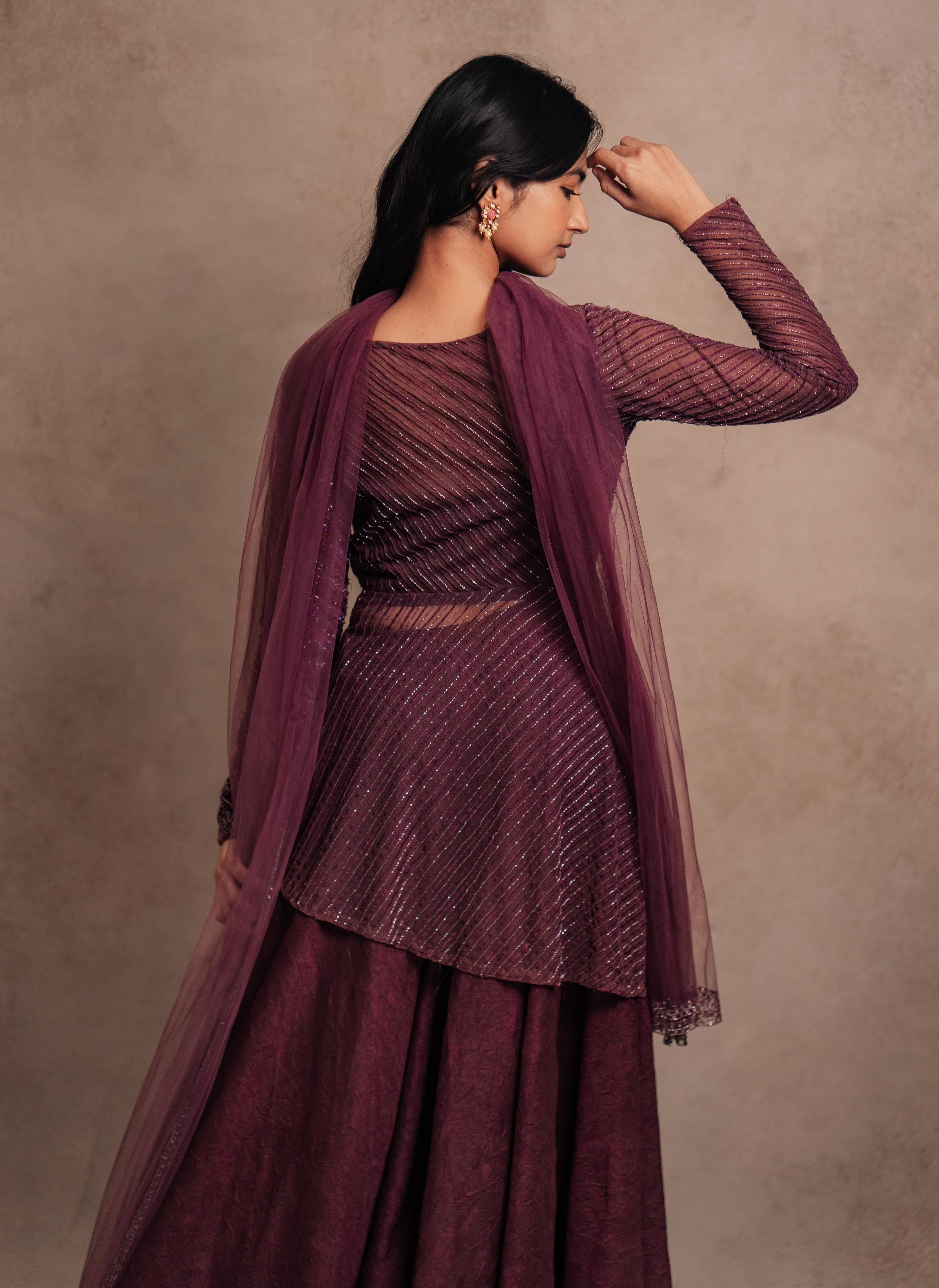 Model Premika Sekar in aubergine peplum sharara posing for full back design
