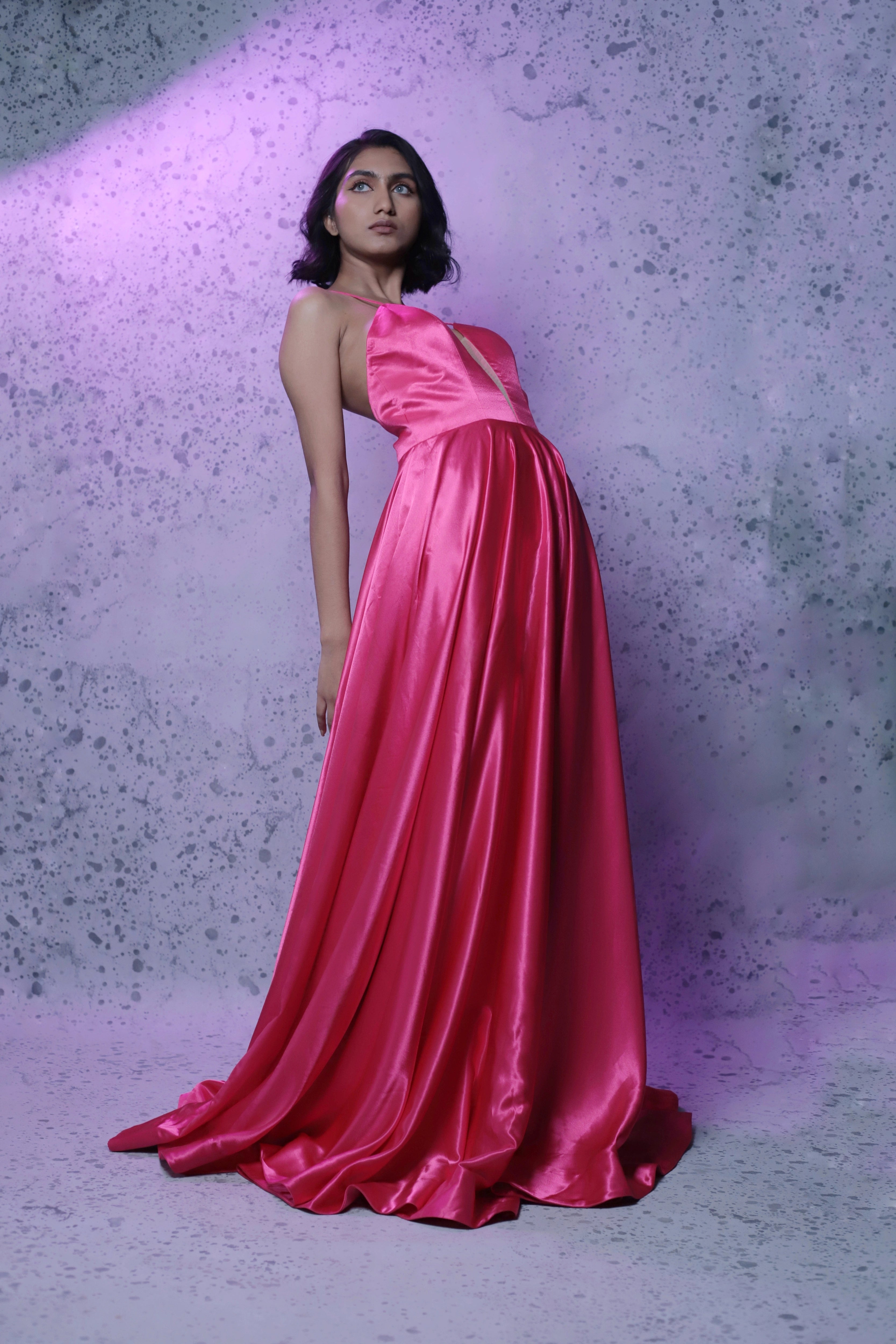 Model Rali Alph posing in a sleeveless pink satin slip dress by team Archana Karthick.
