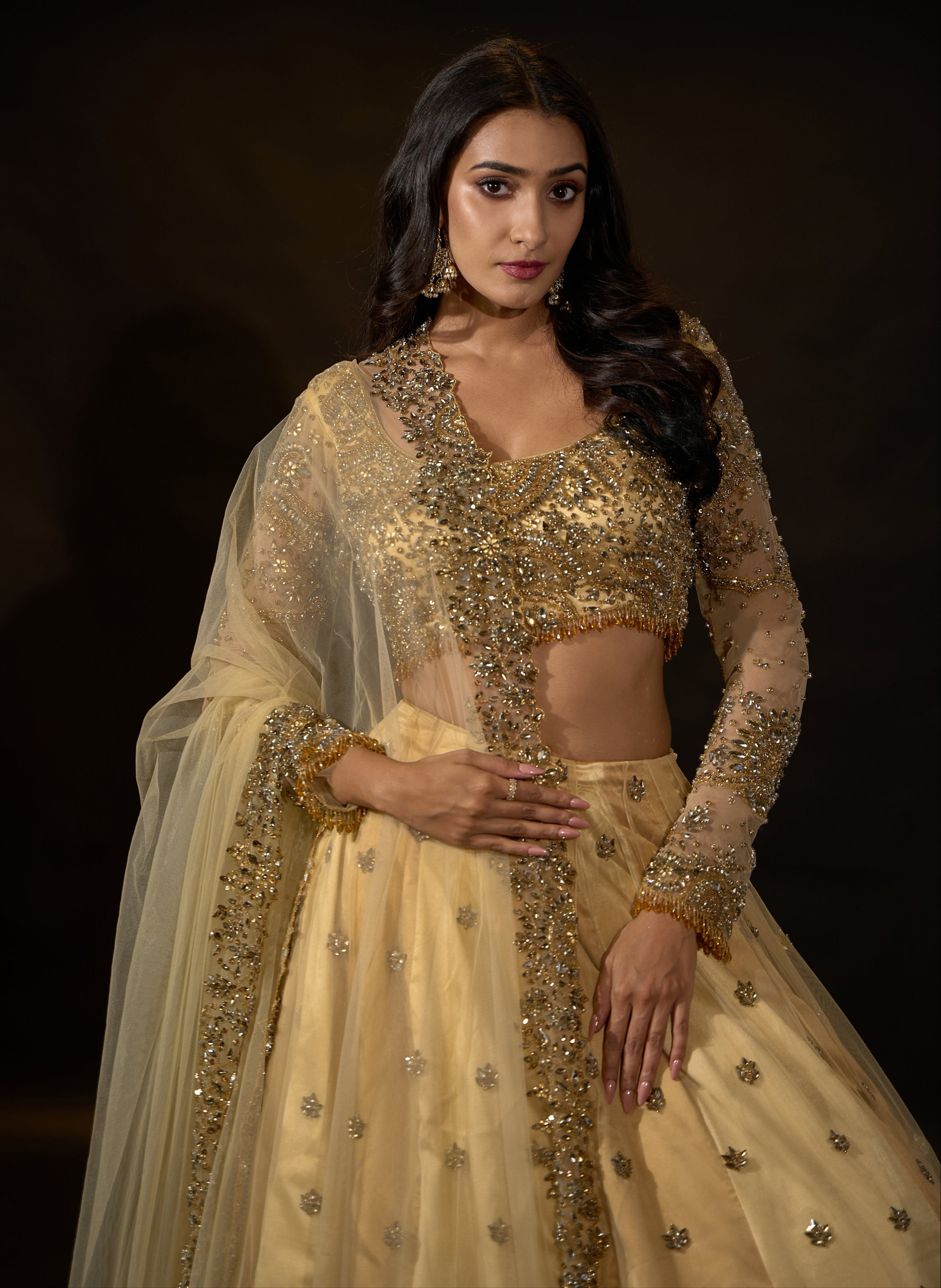 Model Rheyea in a golden beige lehnega by Archana Karthick showcasing the dupatta border and blouse design