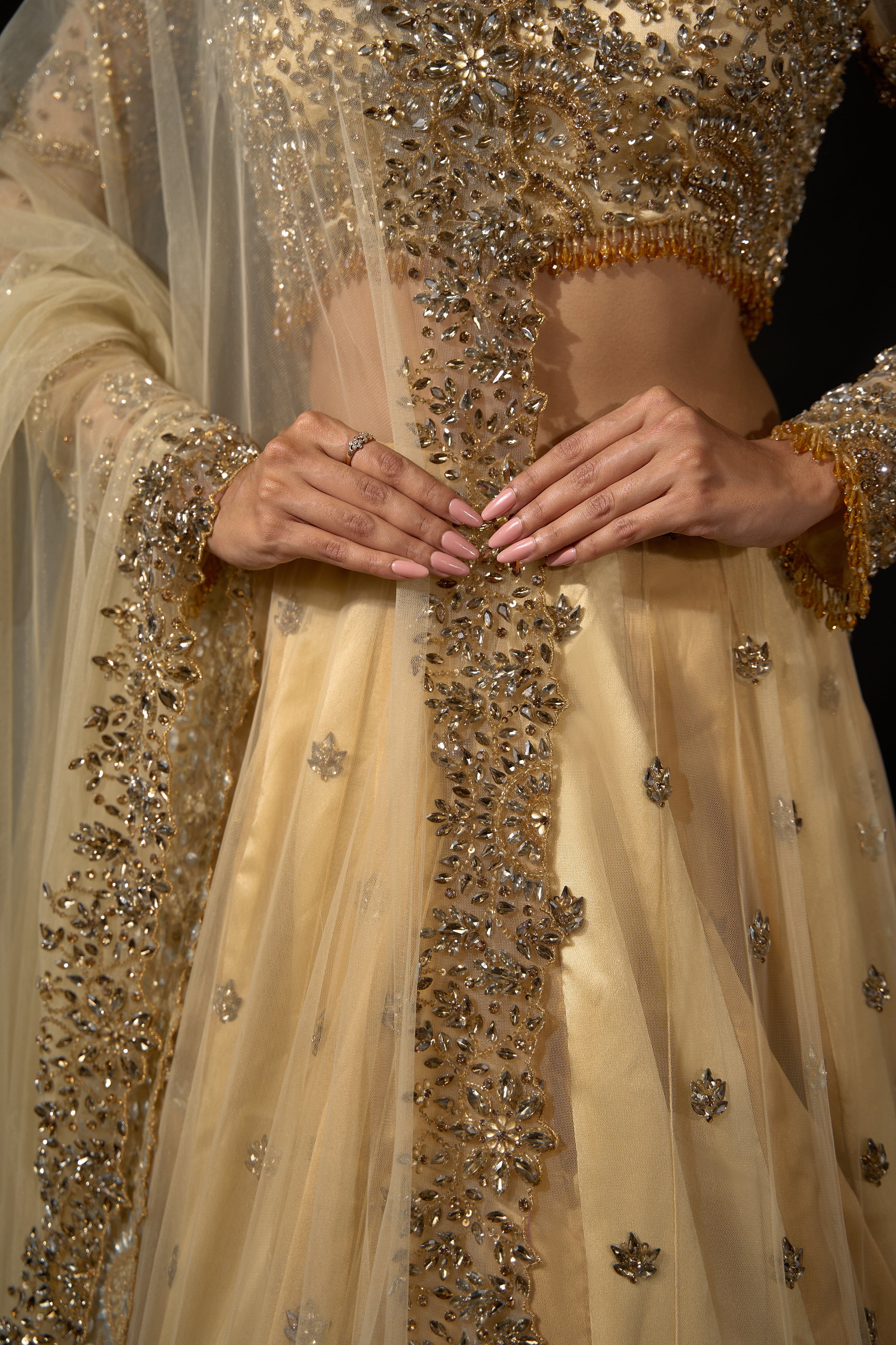 Model Rheyea in a golden beige lehnega by Archana Karthick showcasing the dupatta border design