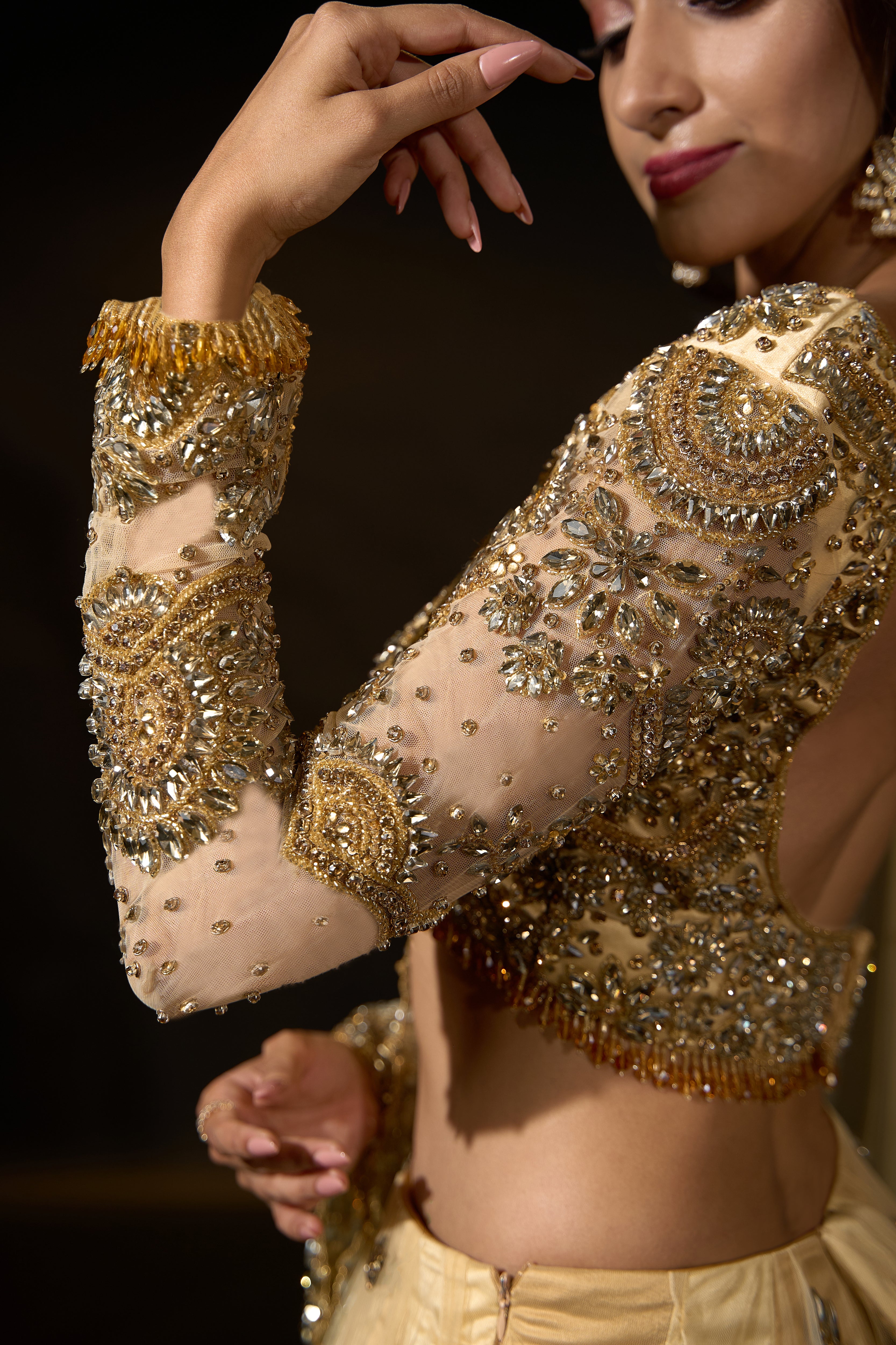 Model Rheyea in a golden beige lehnega by Archana Karthick showcasing the sleeve design