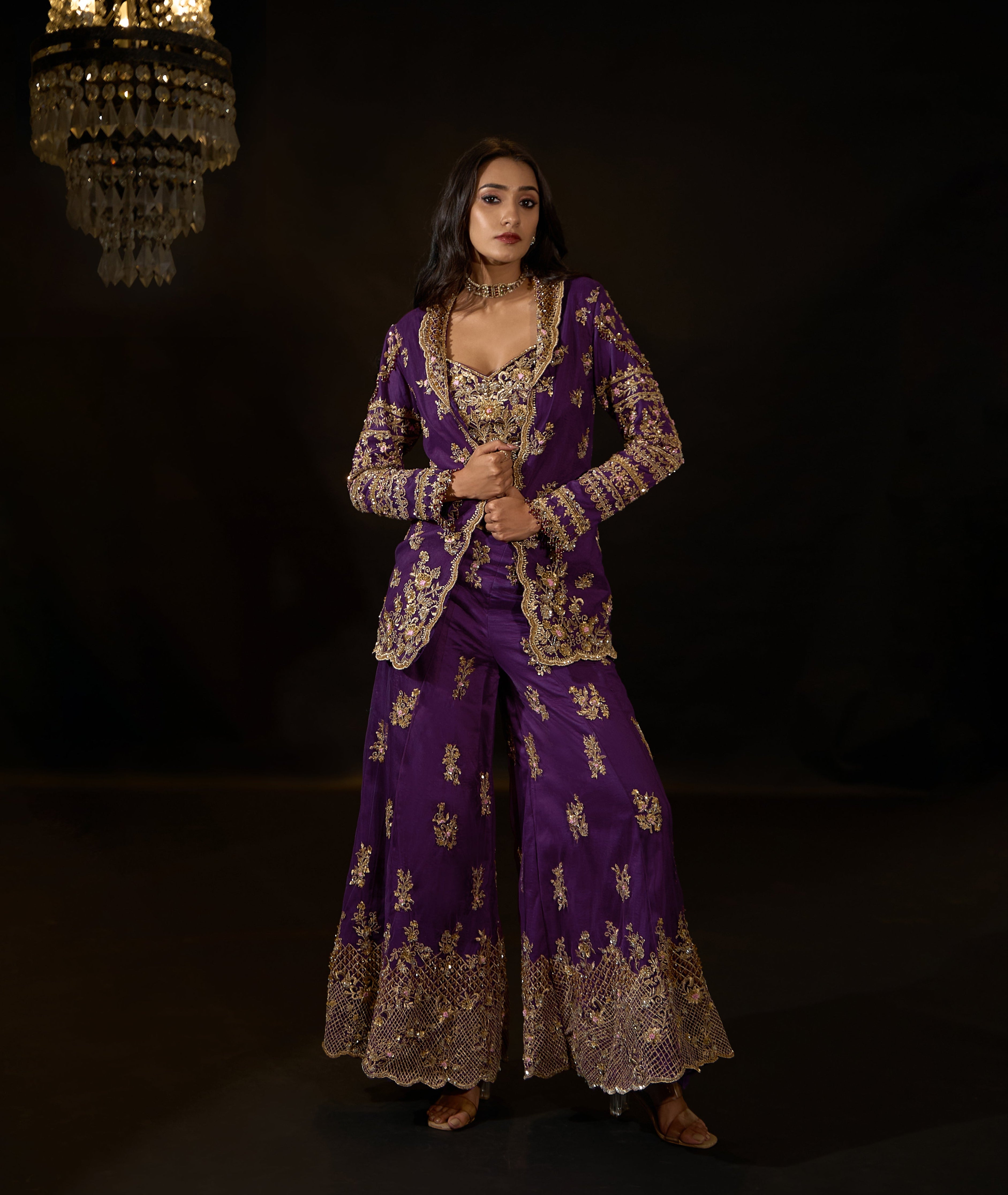 Model Rheyea in a purple jacket dress with bralette and palazzo pants.