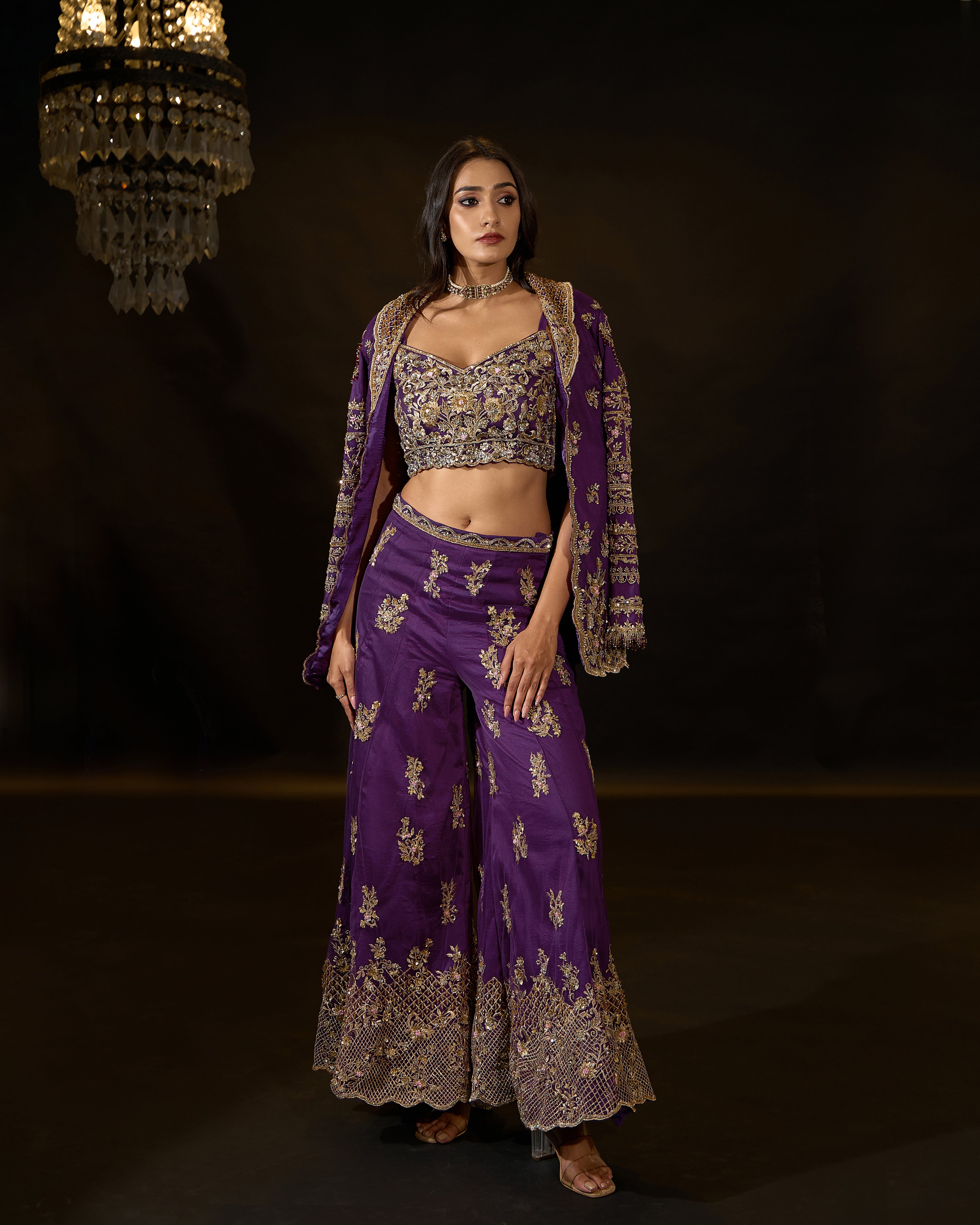 Model Rheyea in a purple jacket dress with bralette and palazzo pants. jacket open bralette detailing.