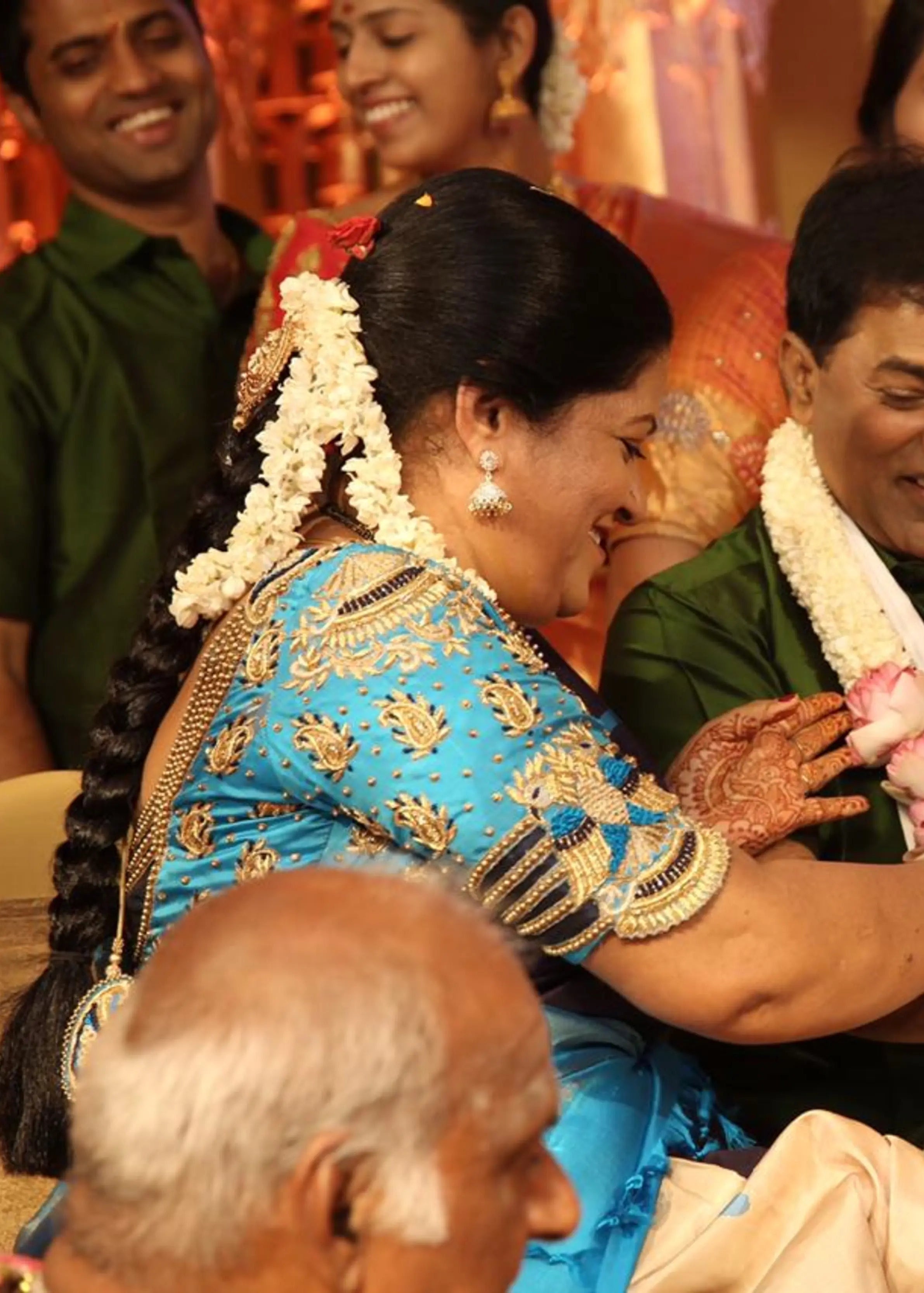 Mother of the bride in a blue silk blouse, handcrafted with beads and resham by team Archana Karthick.