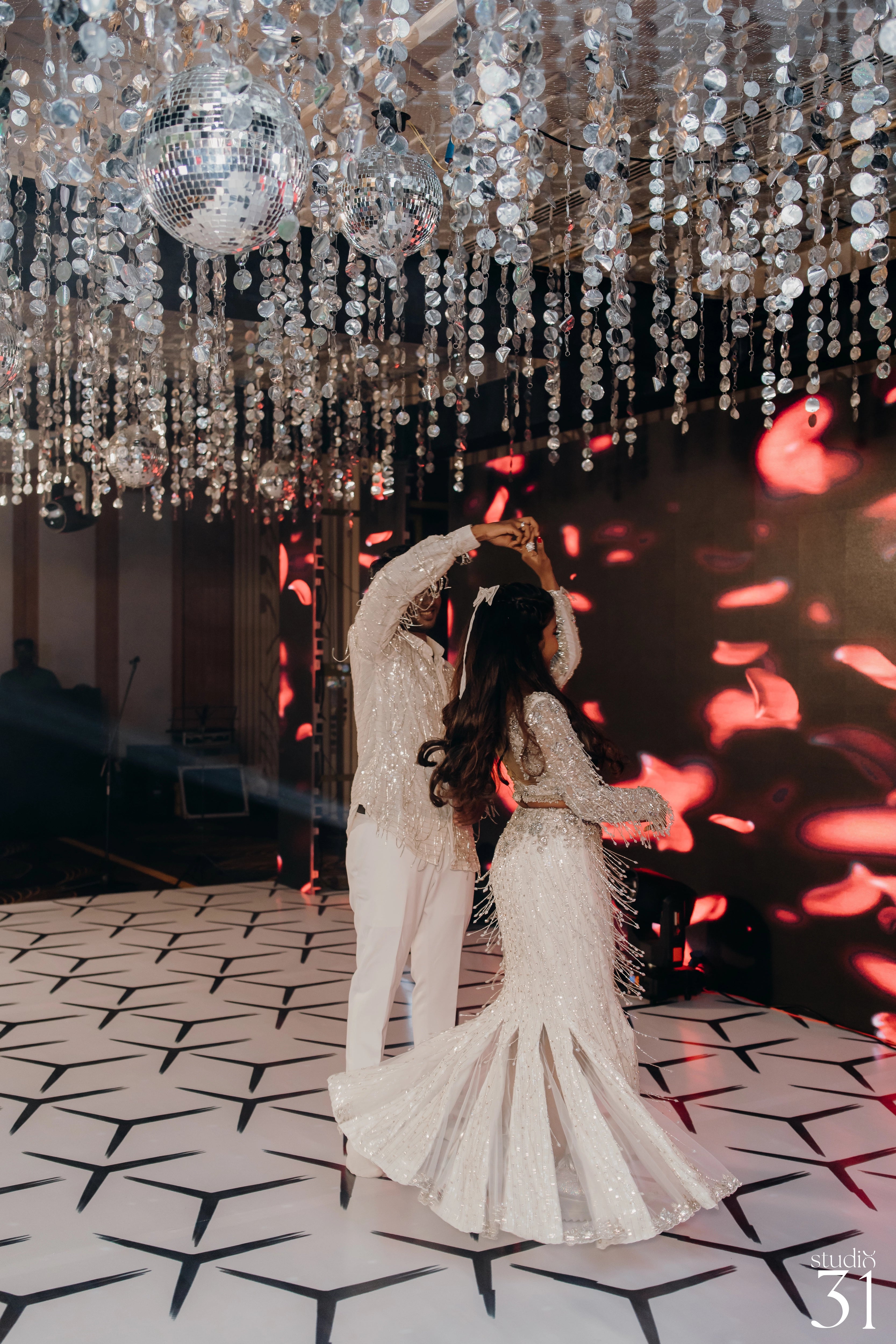 Pooja & Rhevanth dancing in a fusion lehenga and sherwani for their sangeet intricately handcrafted by team Archana Karthick.
