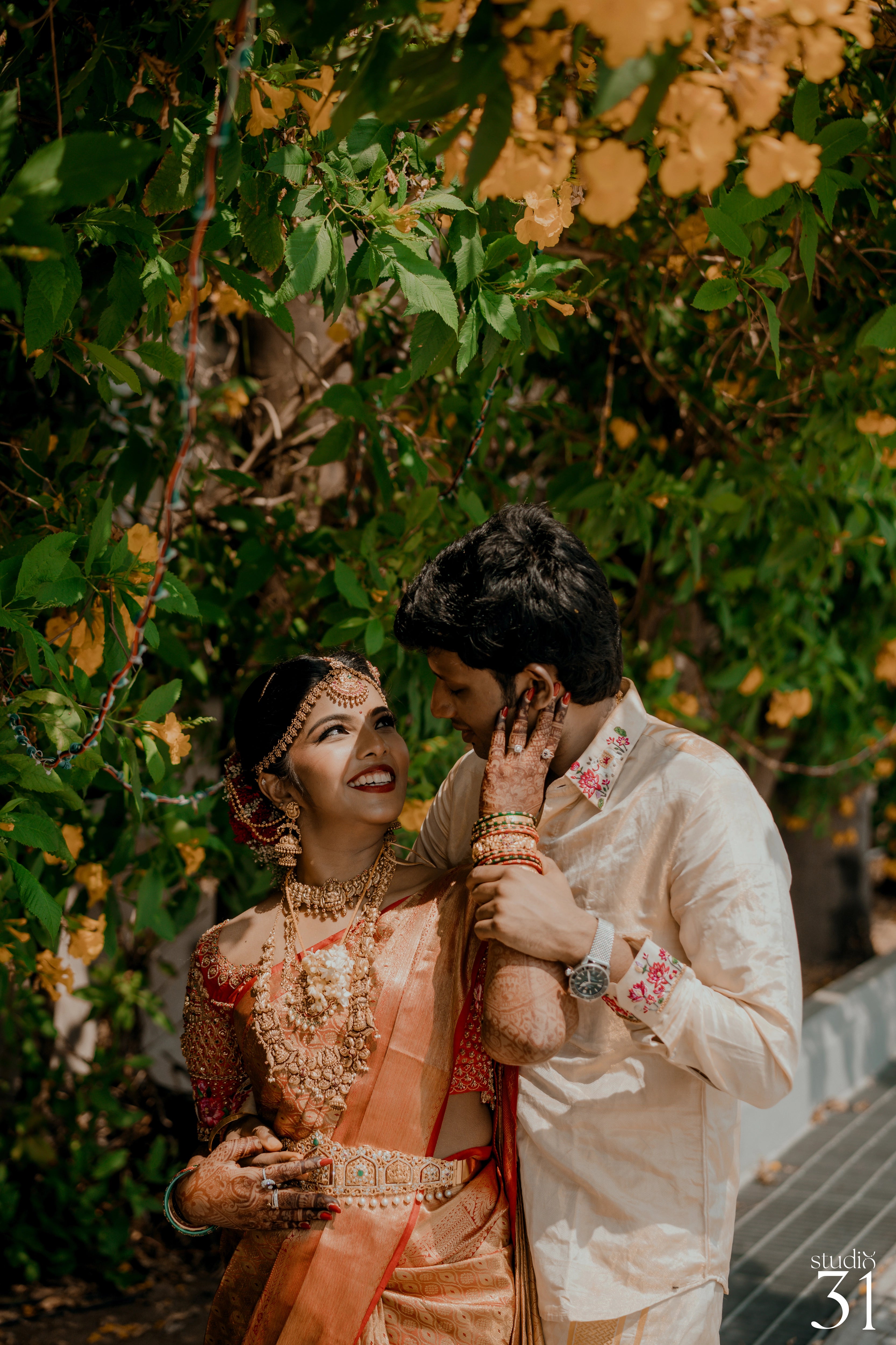 Pooja & Rhevanth during photoshoot for their wedding in red silk blouse and white silk veshti and shirt - intricately handcrafted by team Archana Karthick.