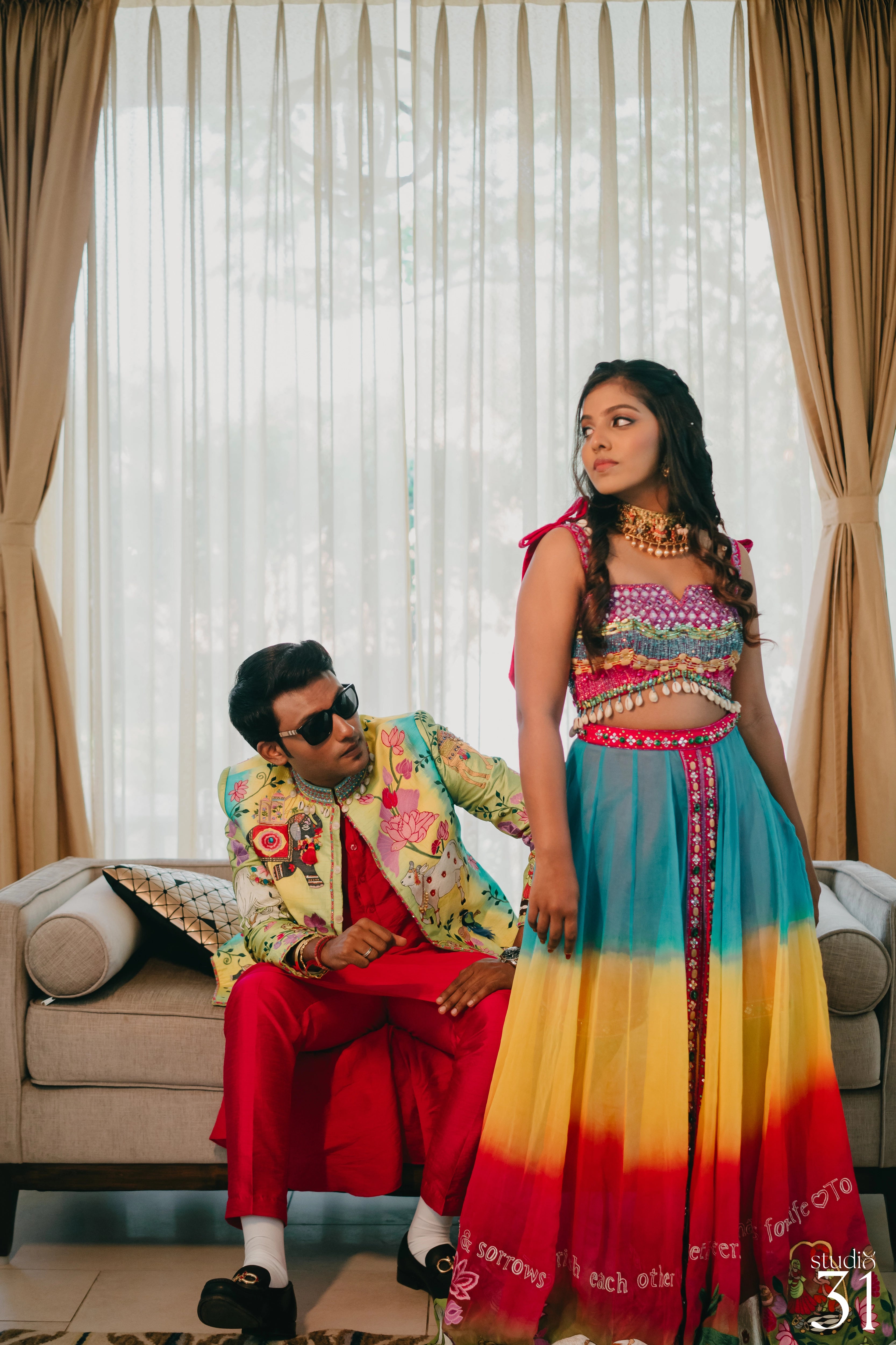 Pooja & Rhevanth in a multi-colored fusion lehenga and bandhgala for their mehendi, dyed and intricately handcrafted by team Archana Karthick.