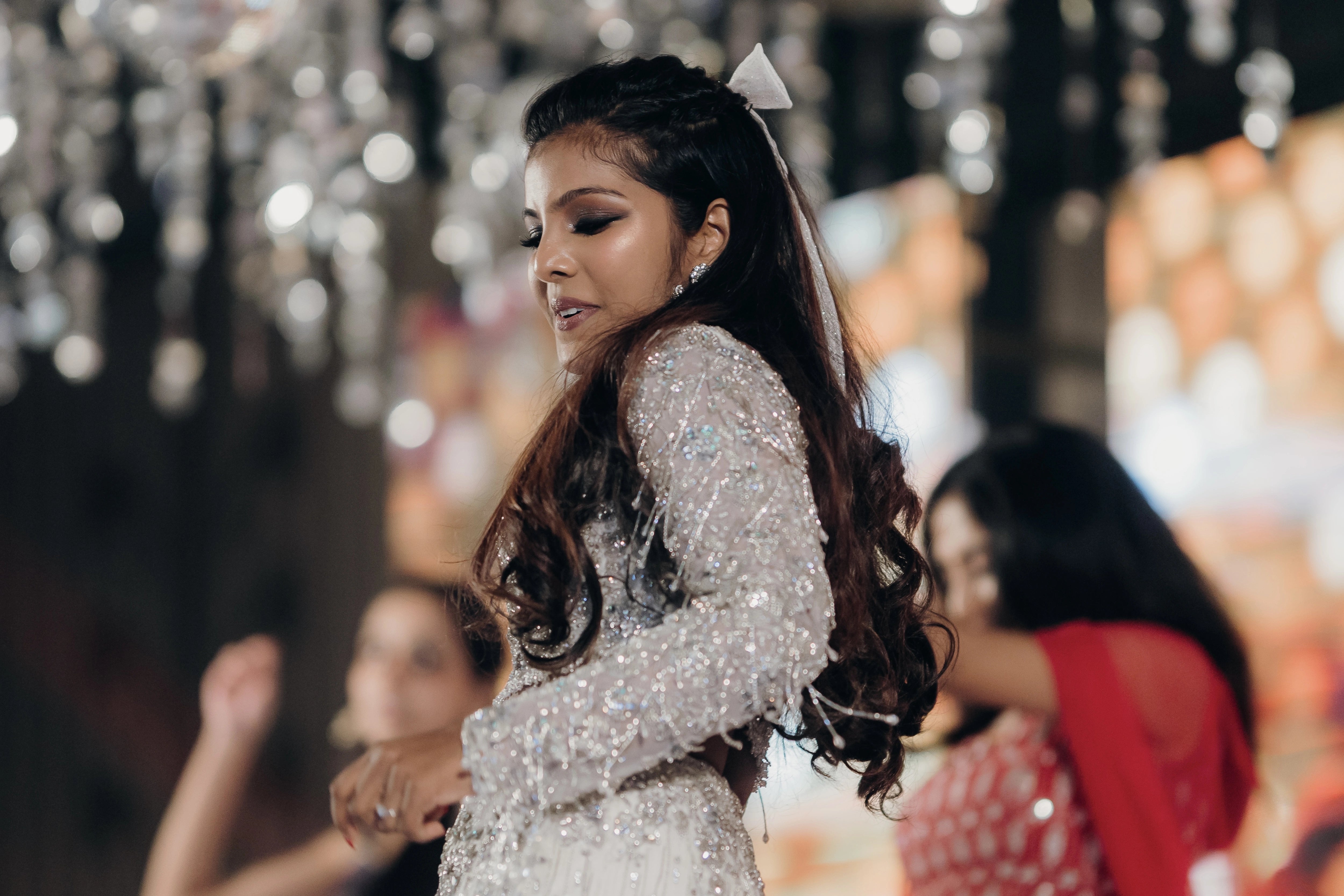 Pooja dancing on stage in a fusion lehenga for her sangeet intricately handcrafted by team Archana Karthick.