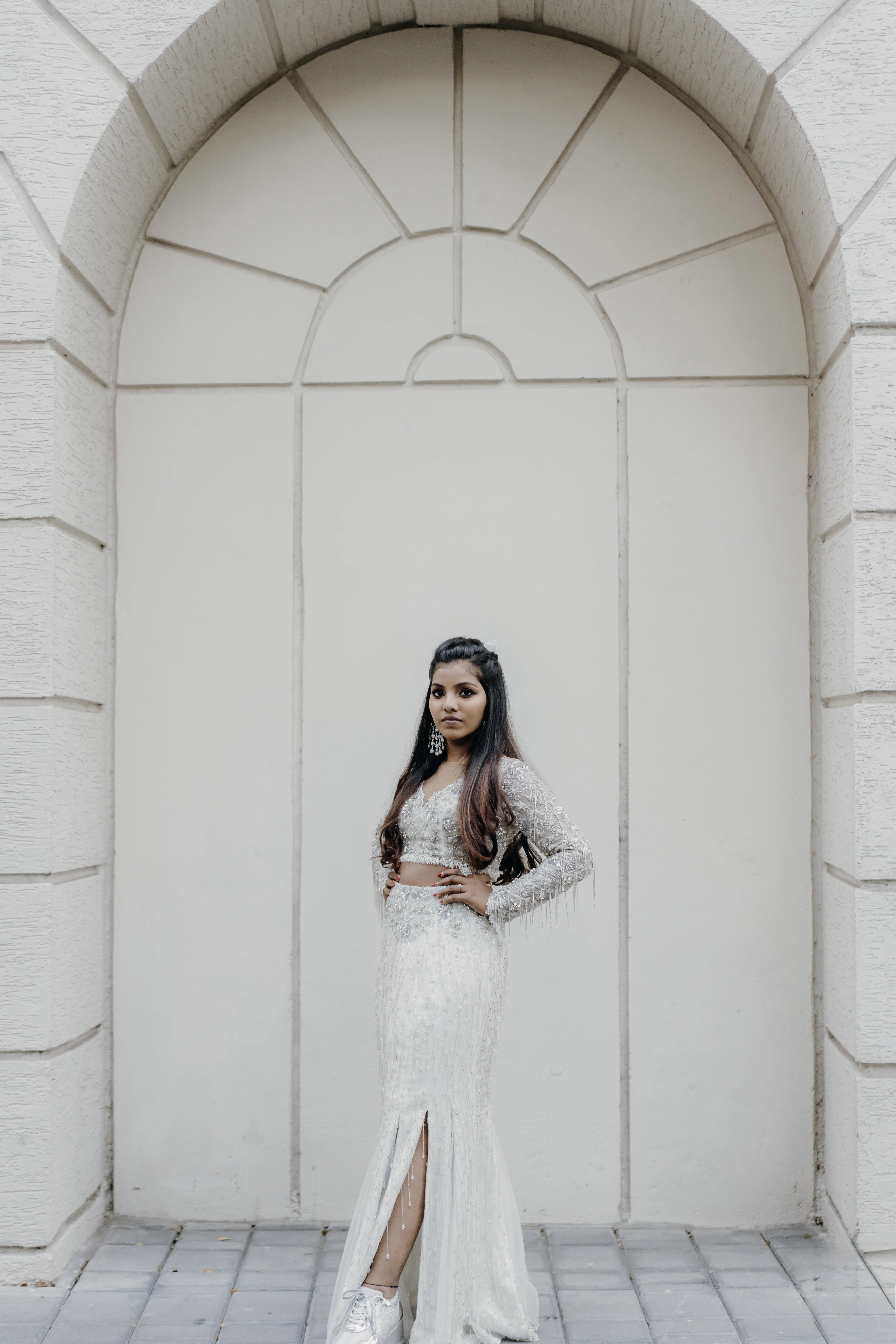 Pooja posing in a fusion lehenga for her sangeet intricately handcrafted by team Archana Karthick.