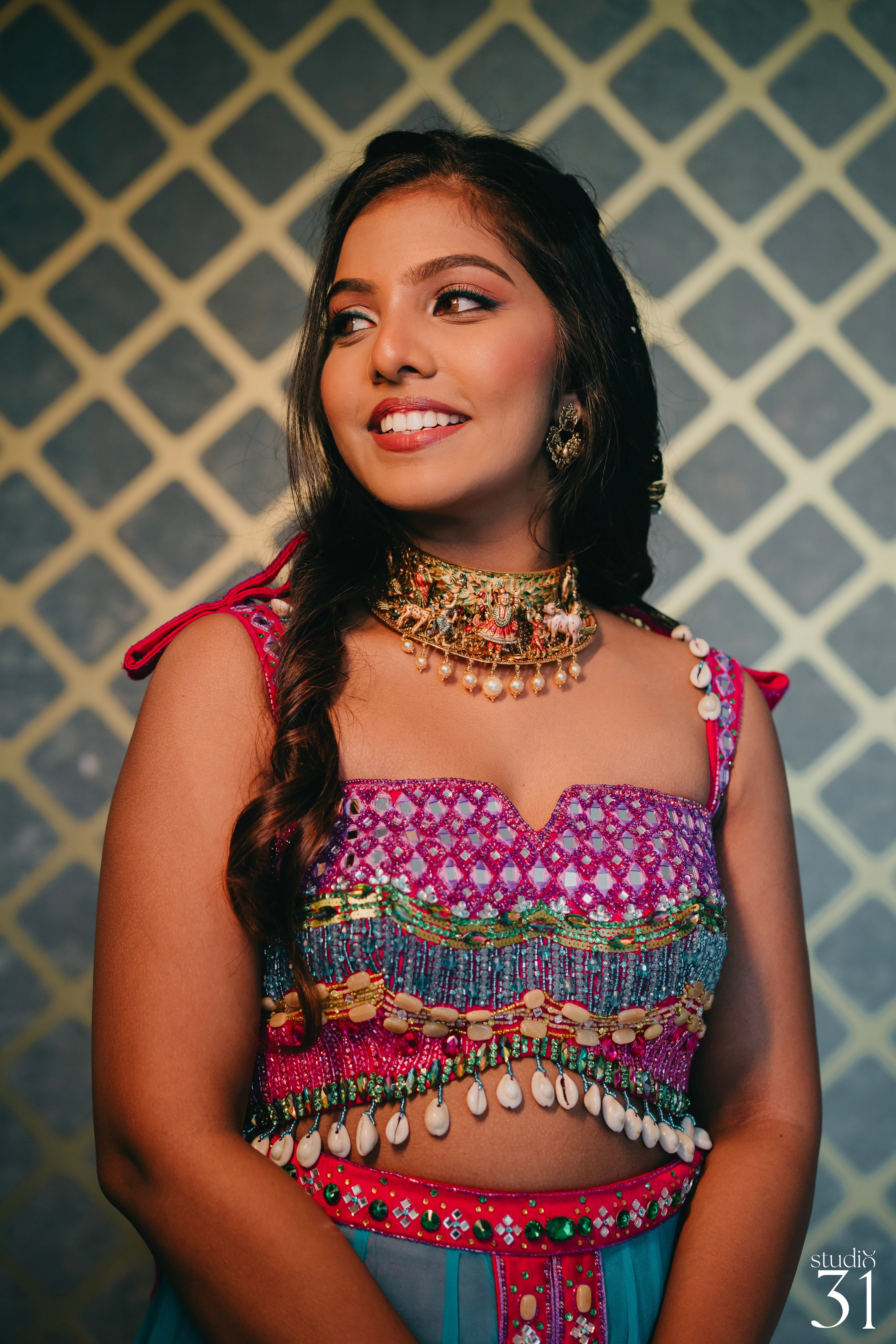 Pooja smiling for shoot in a multi-colored fusion lehenga for her mehendi, dyed and intricately handcrafted by team Archana Karthick.