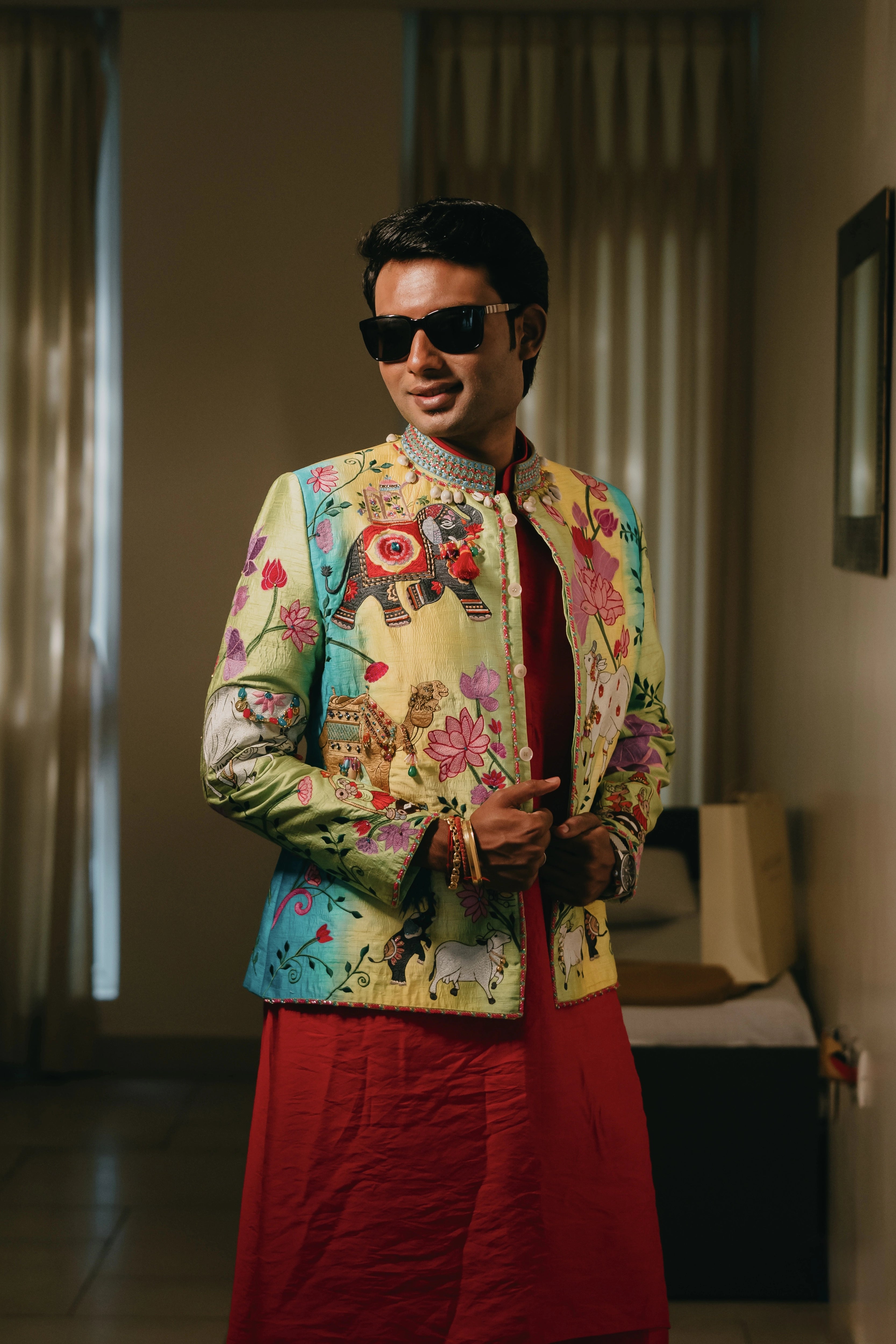 Rhevanth in a multi-colored fusion bandhgala for his mehendi, dyed and intricately handcrafted by team Archana Karthick.