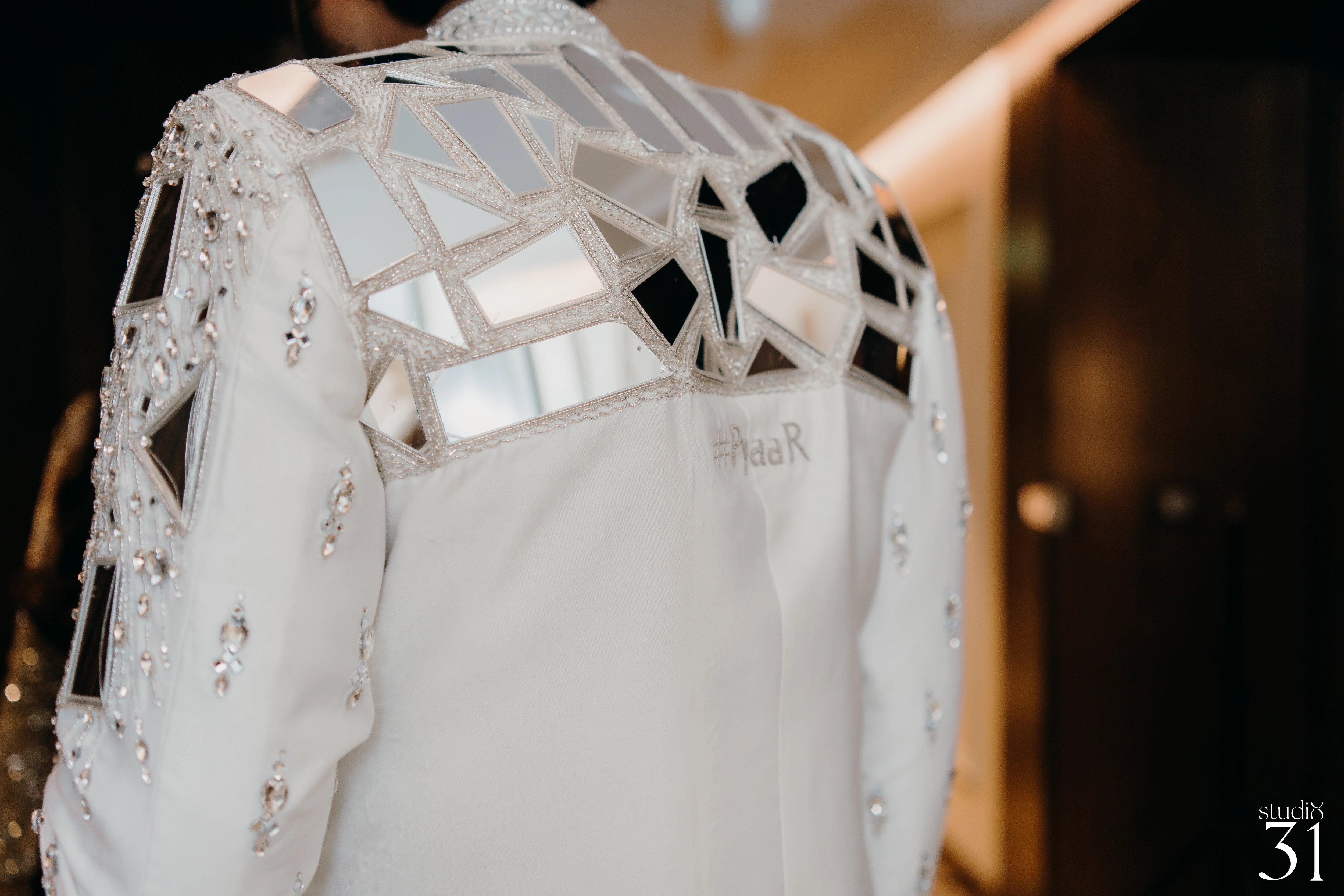 Rhevanth posing for back design in a fusion sherwani for his sangeet intricately handcrafted by team Archana Karthick.