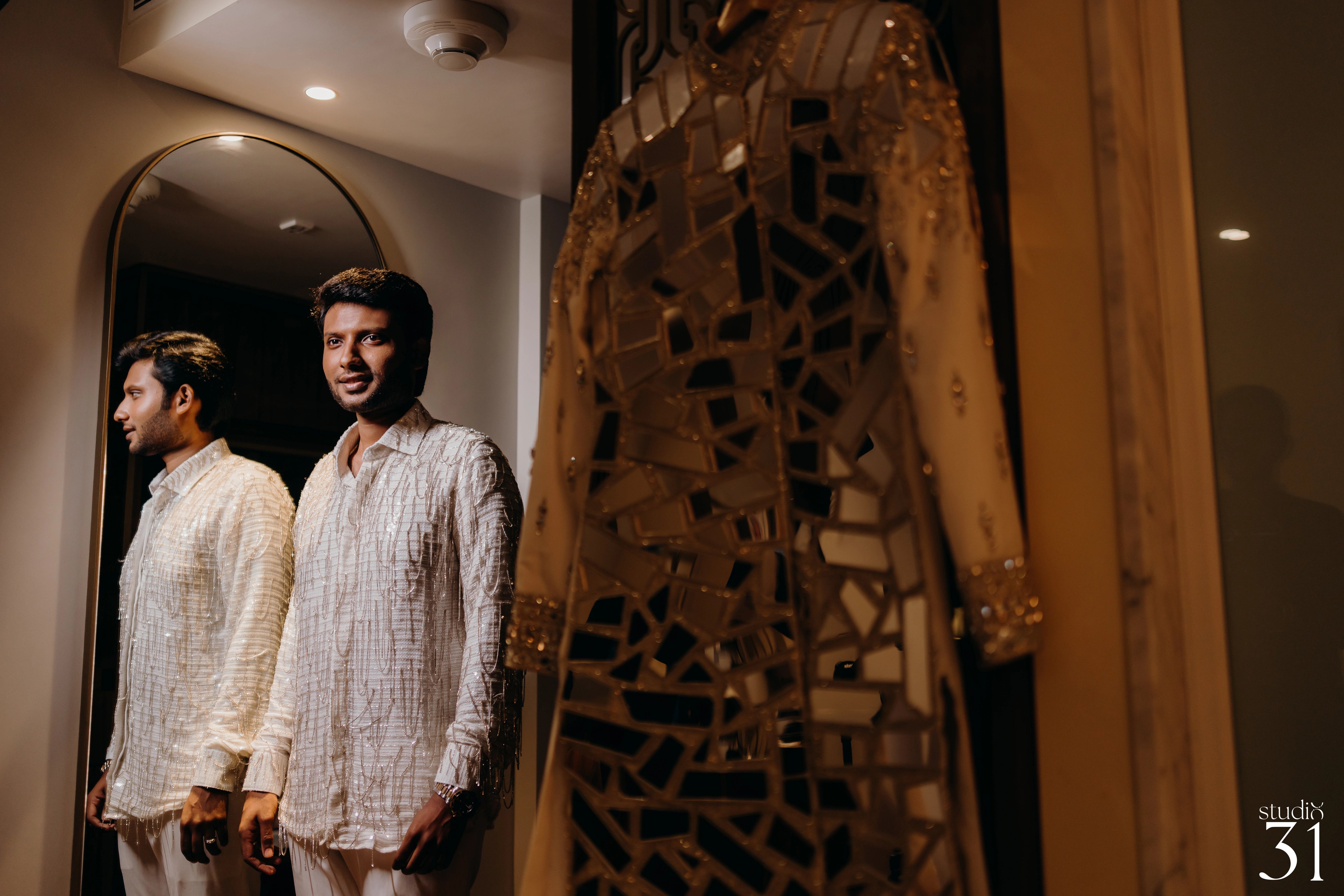 Rhevanth posing in a fusion sherwani for his sangeet intricately handcrafted by team Archana Karthick.